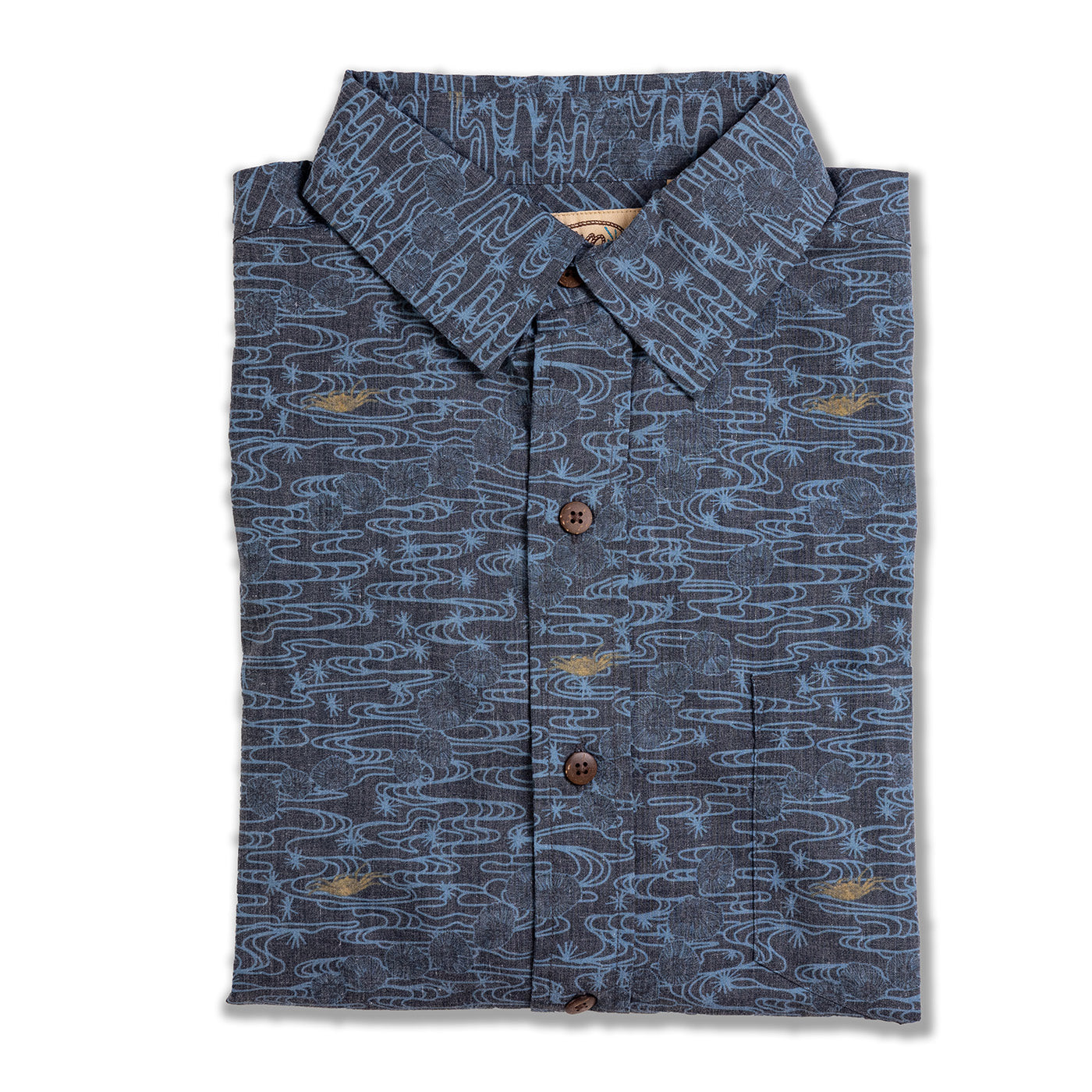 Folded blue patterned shirt on a white background