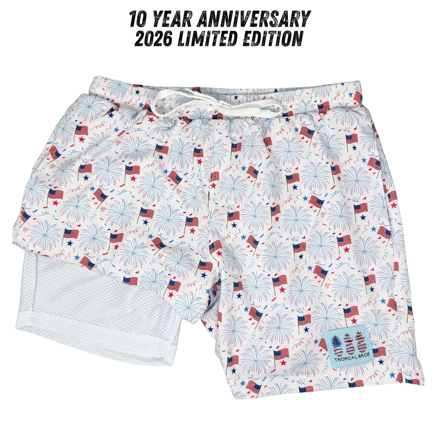 Shorts with American flag and fireworks pattern on a white background, labeled '10 Year Anniversary 2026 Limited Edition'.