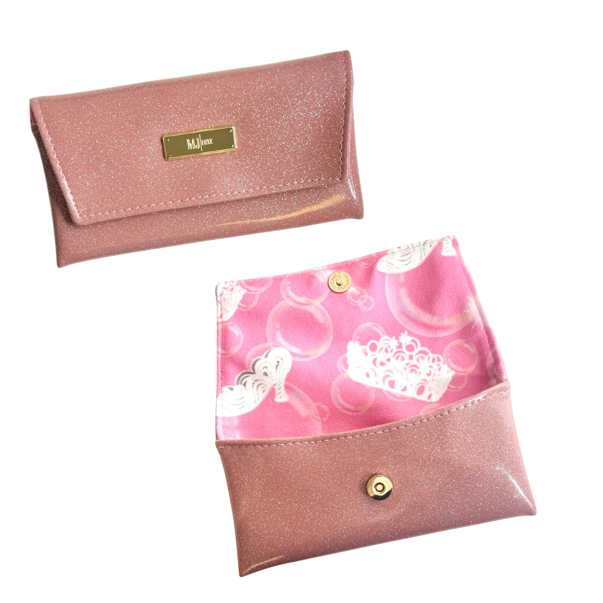 Two pink glittery pouches with decorative designs on a white background