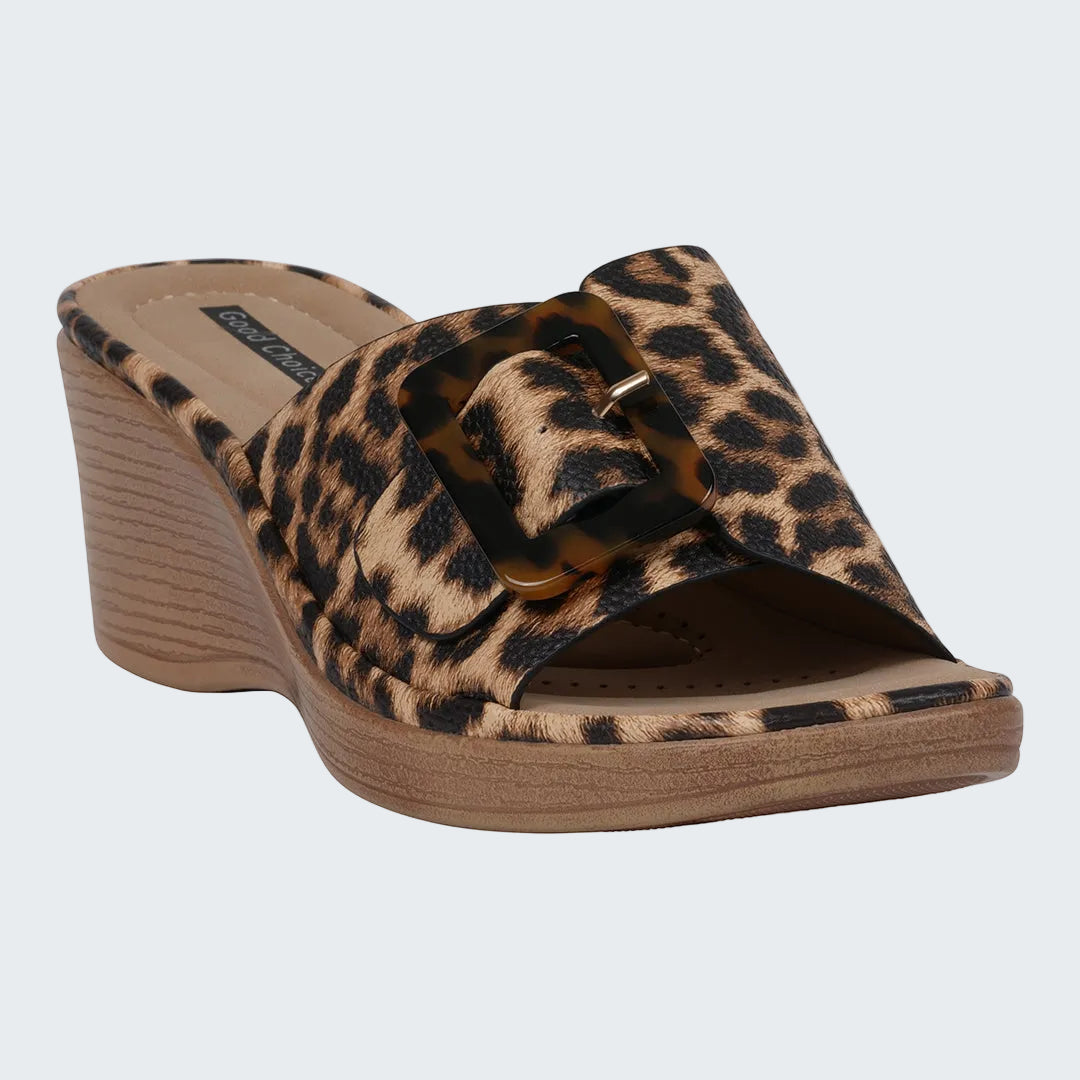 Leopard print wedge sandal with wooden sole on a white background
