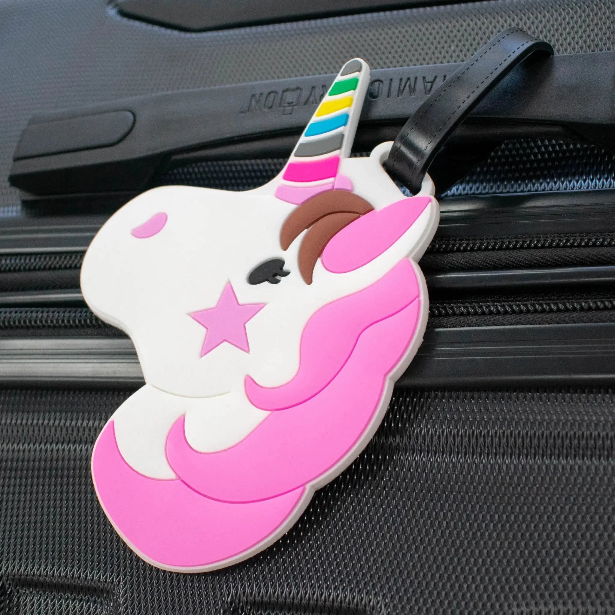 Unicorn-shaped luggage tag on a suitcase