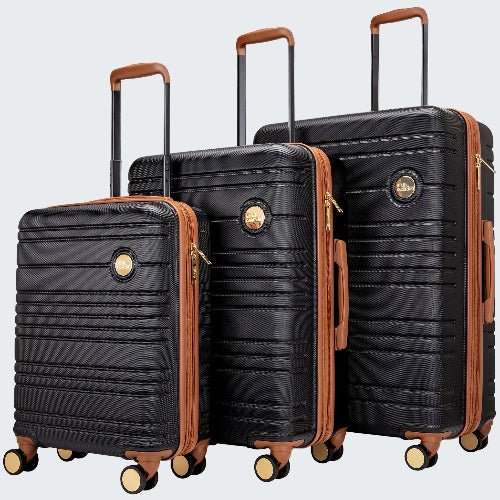 Set of black suitcases with brown handles and accents on a white background