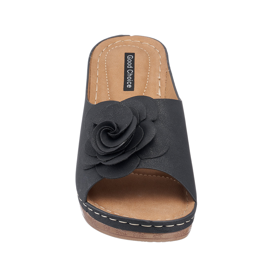 Black sandal with a flower detail on a white background
