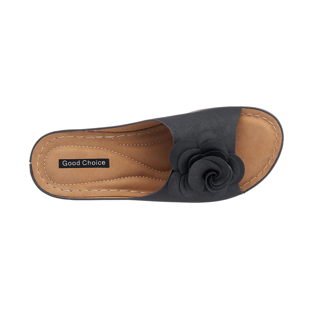 Black sandal with a flower detail on a white background
