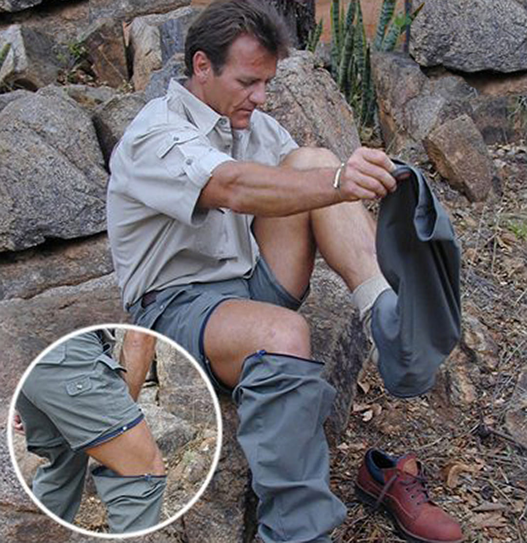 Man sitting on rocks wearing gray hiking leg covers, with a close-up inset showing the leg cover details.