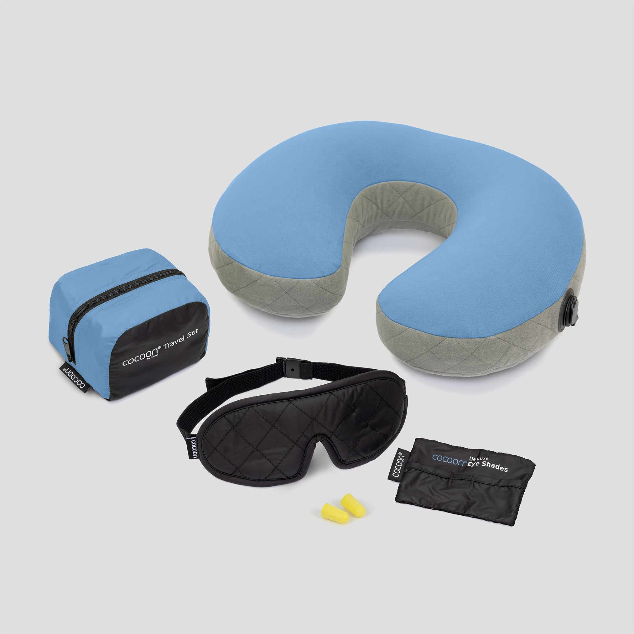 Travel pillow, eye mask, earplugs, and carrying case on a light gray background
