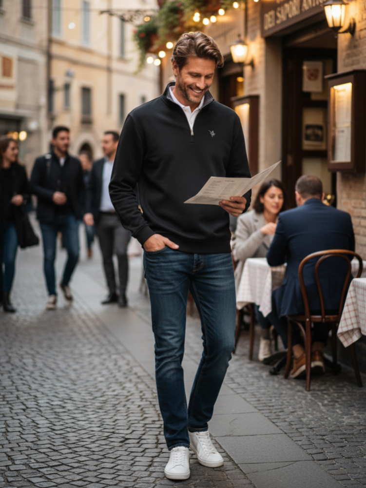 Man walking down a street holding a menu, with people dining in the background