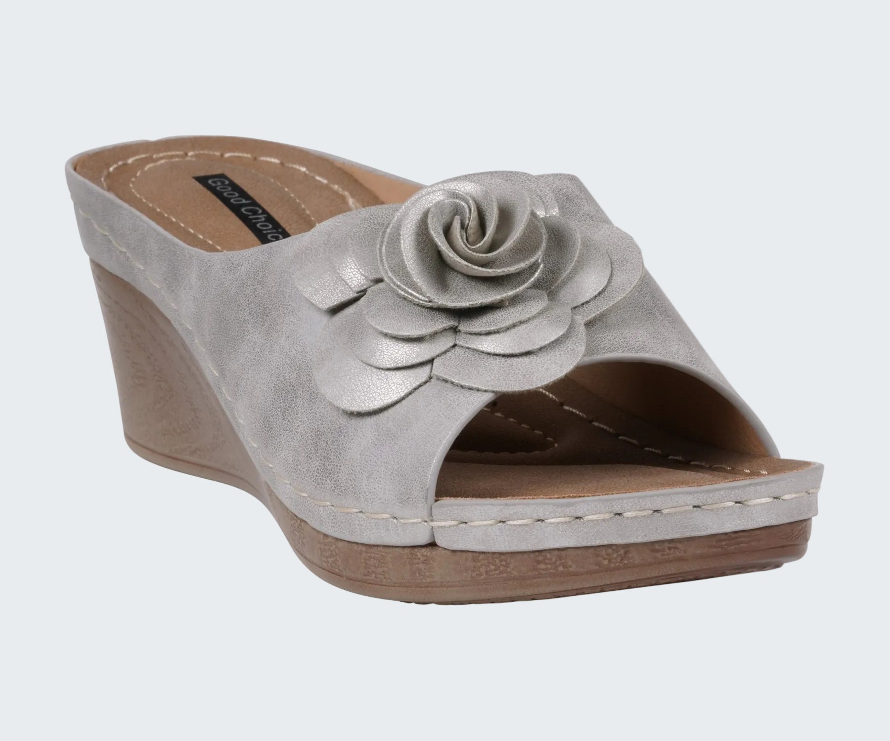 Gray wedge sandal with a floral design on a white background