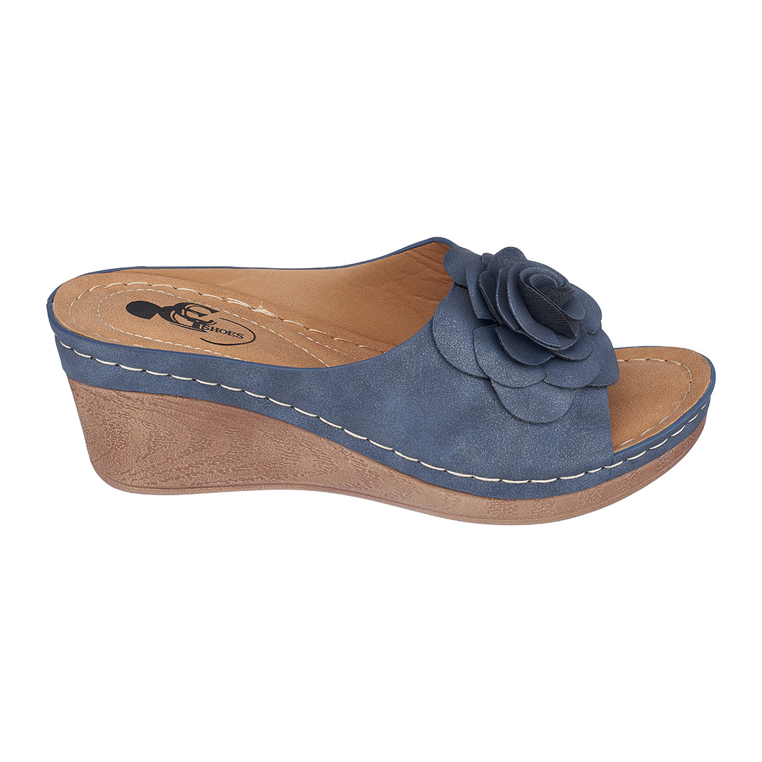 Blue wedge sandal with a flower detail on a white background