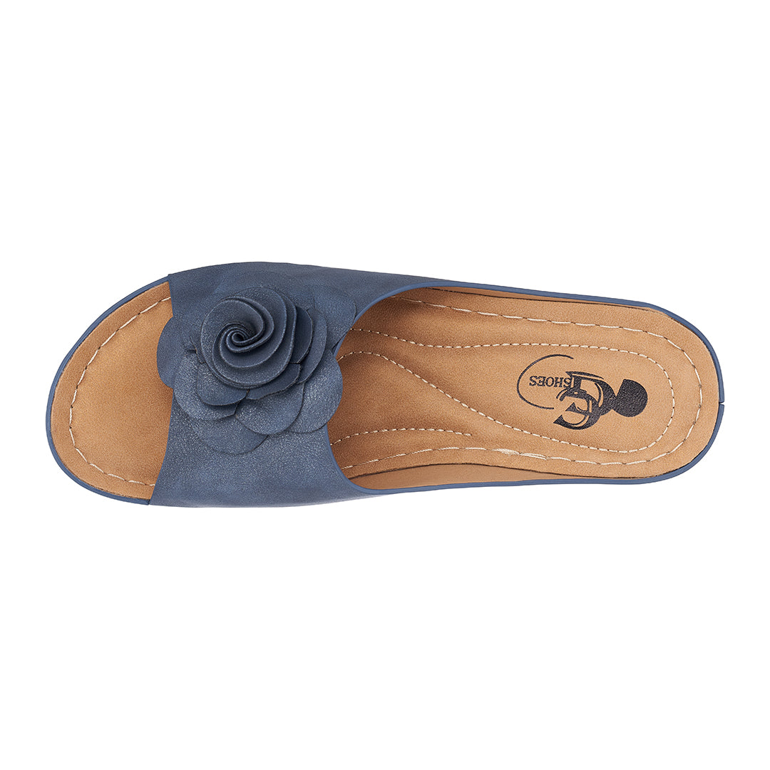 Blue sandal with a flower detail on a white background