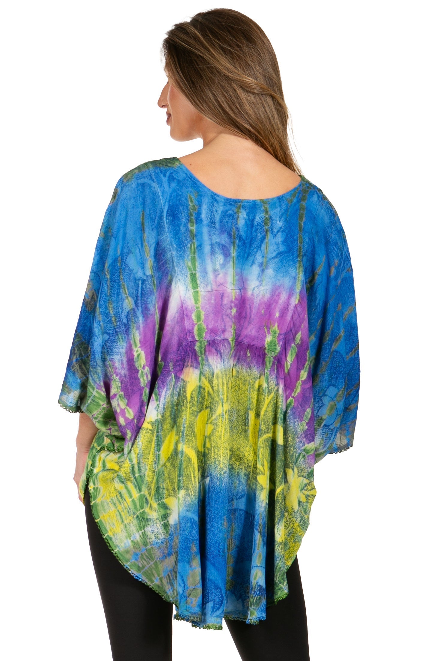 Woman wearing a colorful tie-dye shirt with a white background