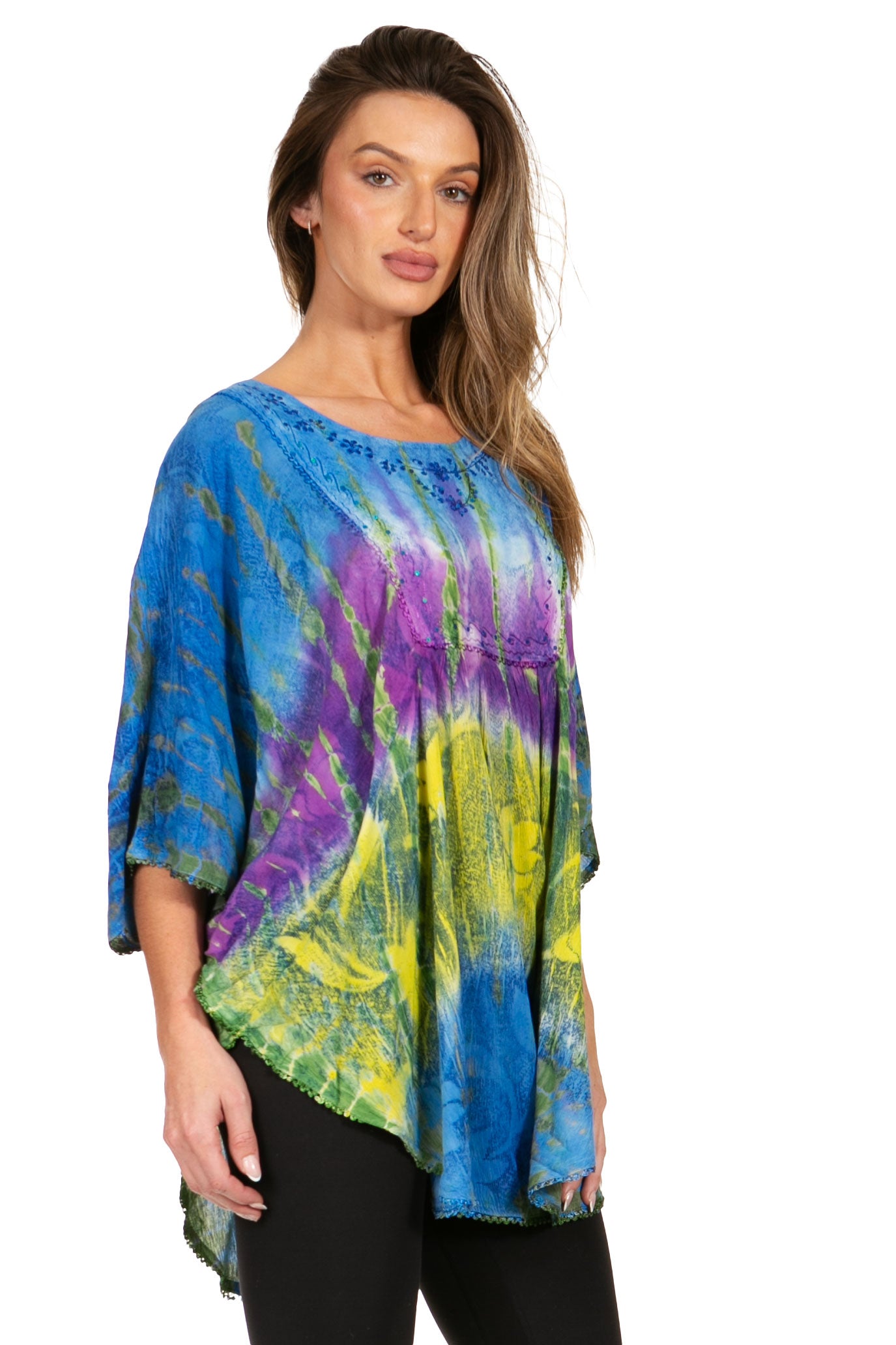 Woman wearing a colorful tie-dye shirt on a white background