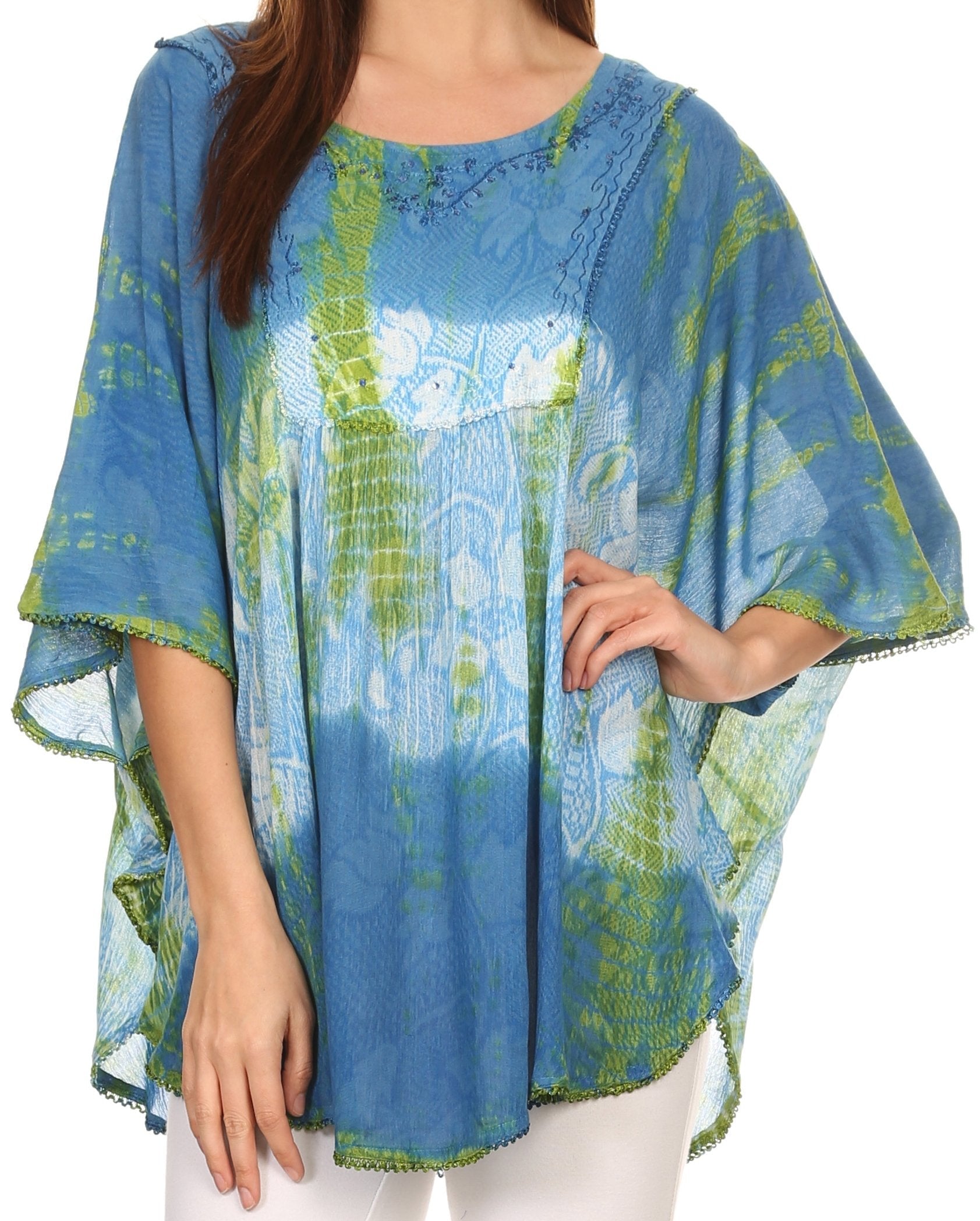 Woman wearing a blue and green patterned poncho on a white background
