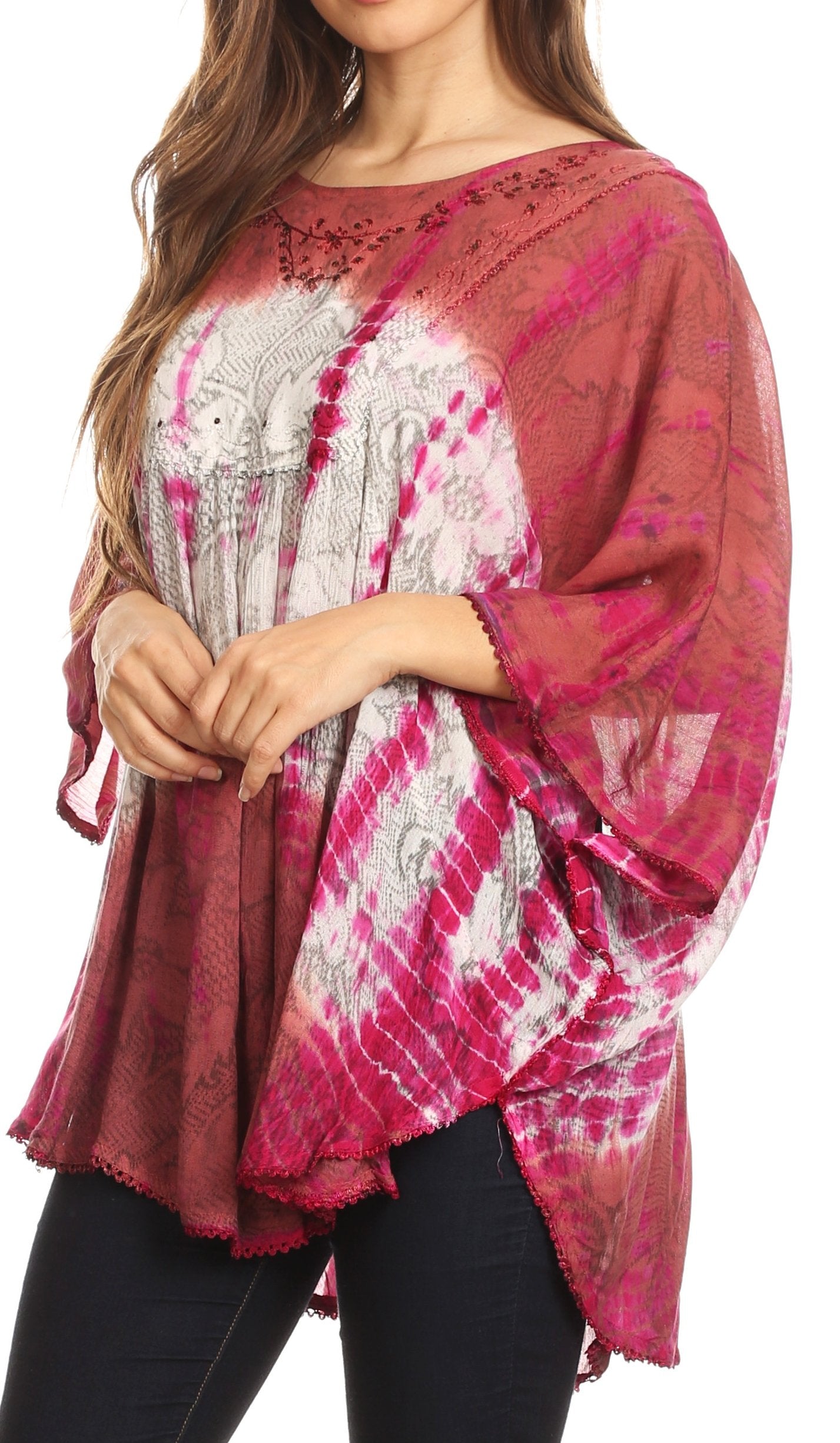 Woman wearing a pink and white patterned top with long sleeves.
