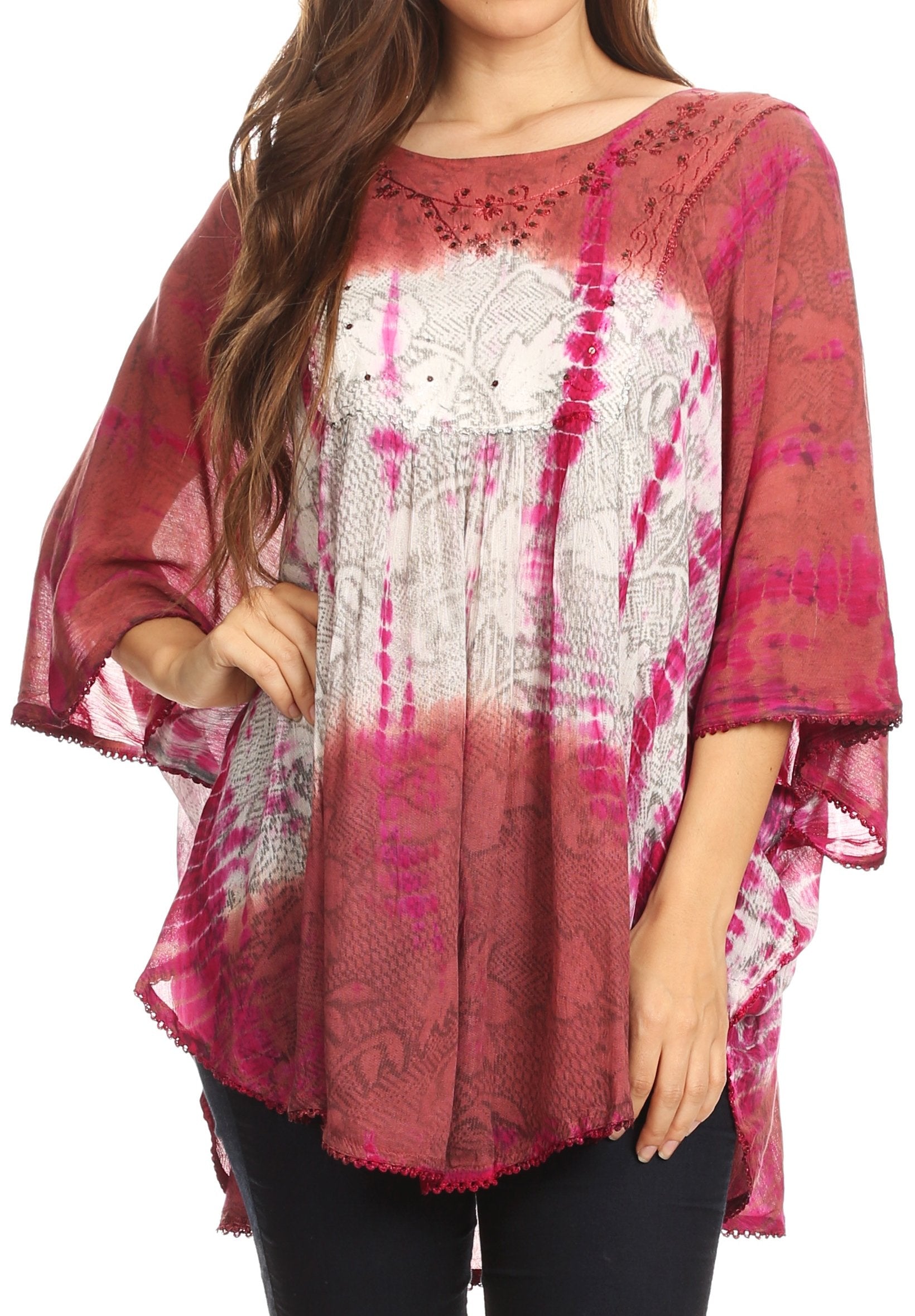 Woman wearing a pink and white patterned top with a sheer overlay on a white background