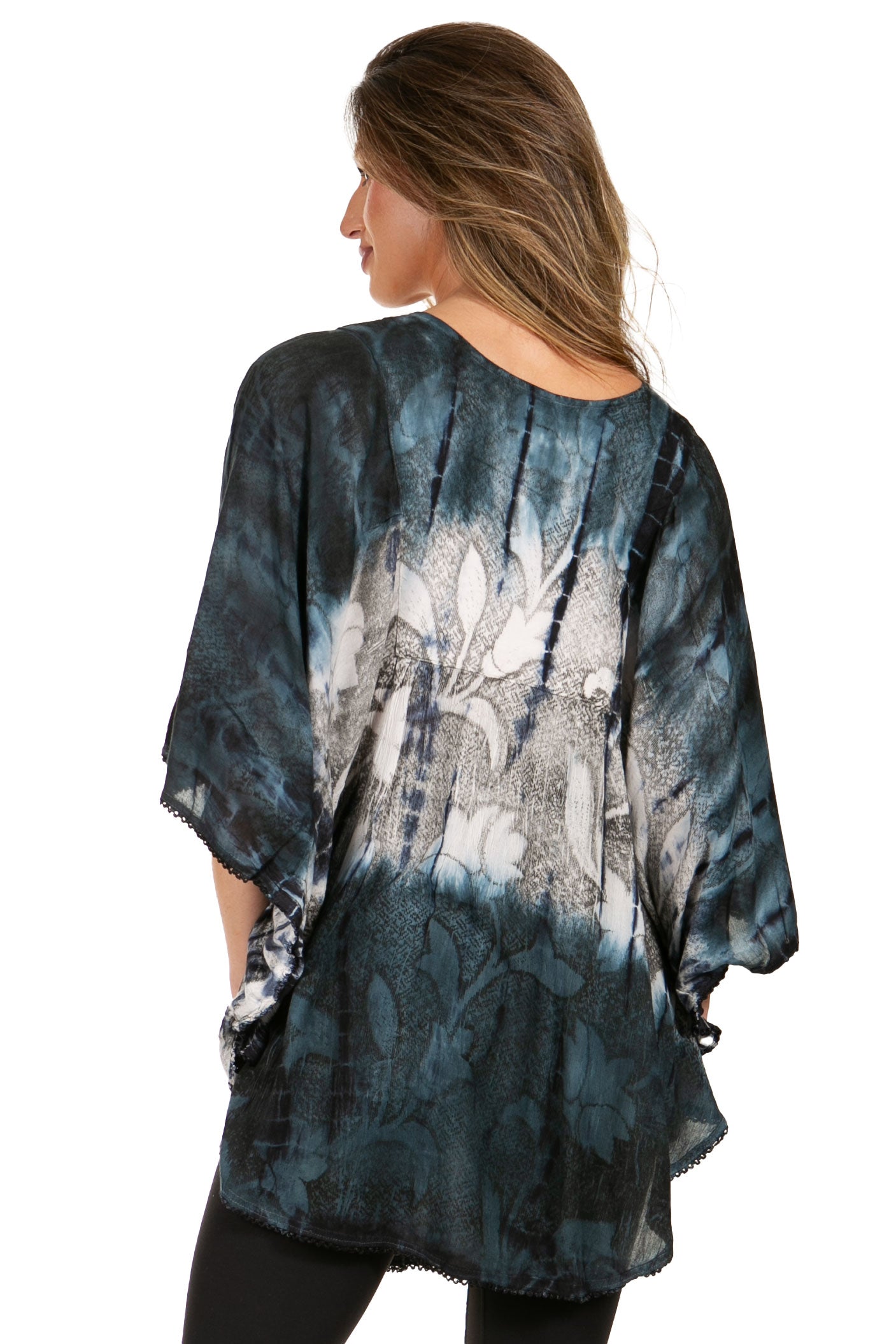 Woman wearing a blue tie-dye kimono-style top on a white background