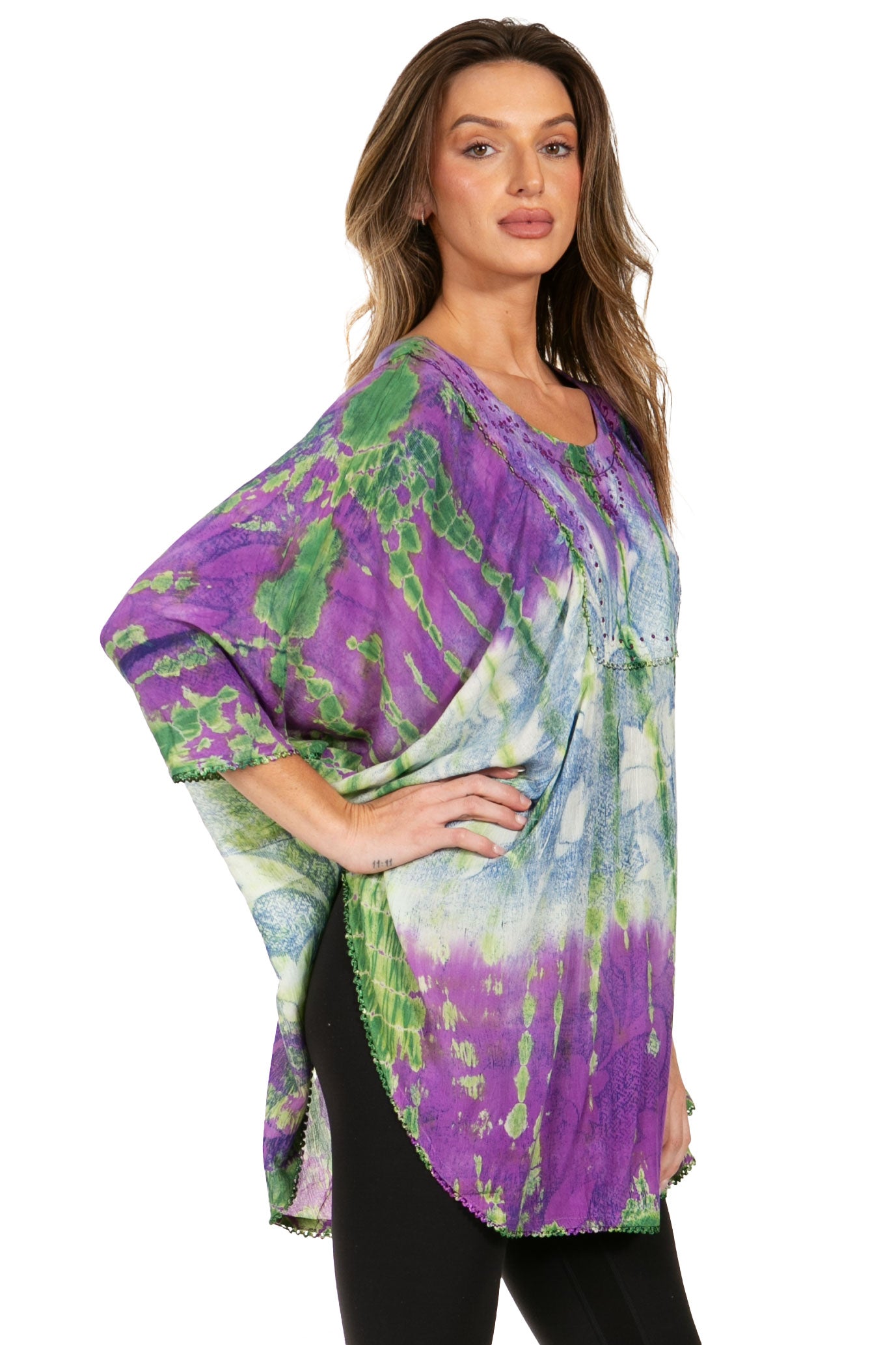 Woman wearing a colorful tie-dye kimono-style top on a white background