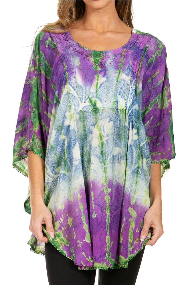 Purple, green, and blue tie-dye top worn by a person on a white background