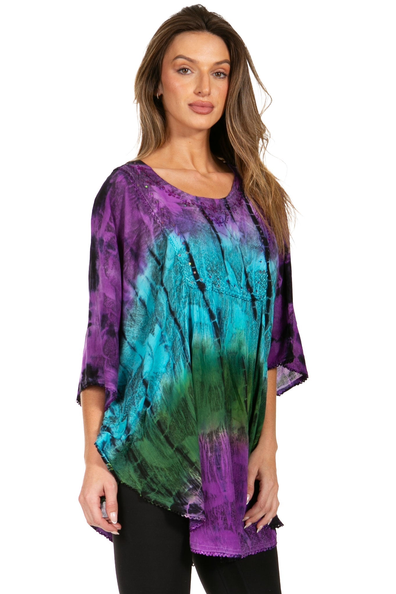 Woman wearing a tie-dye shirt with purple, green, and blue colors on a white background