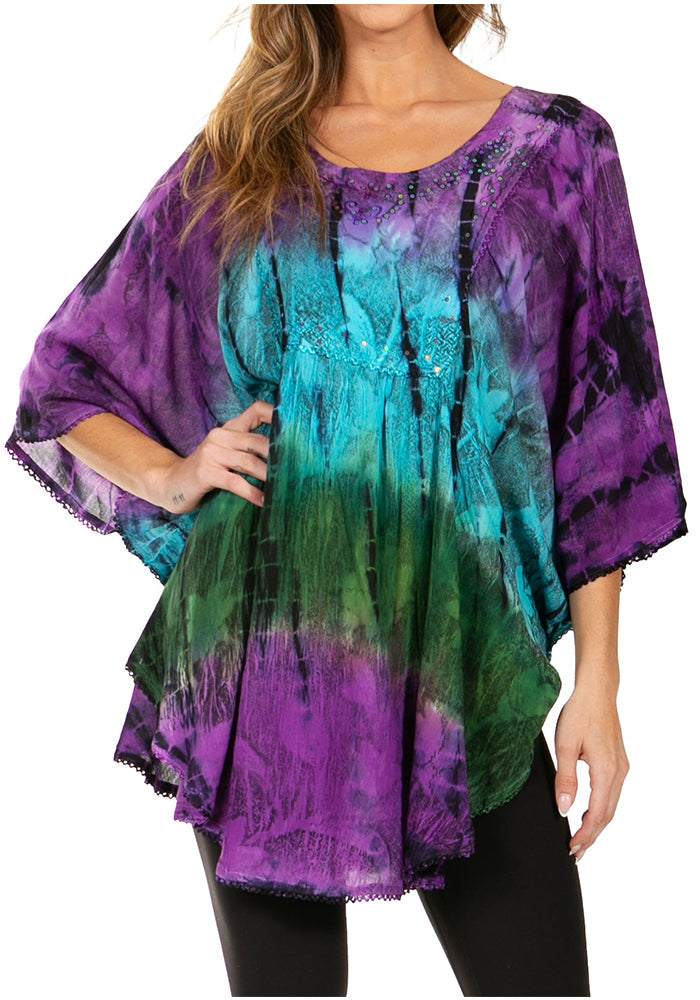 Woman wearing a colorful tie-dye top with a white background