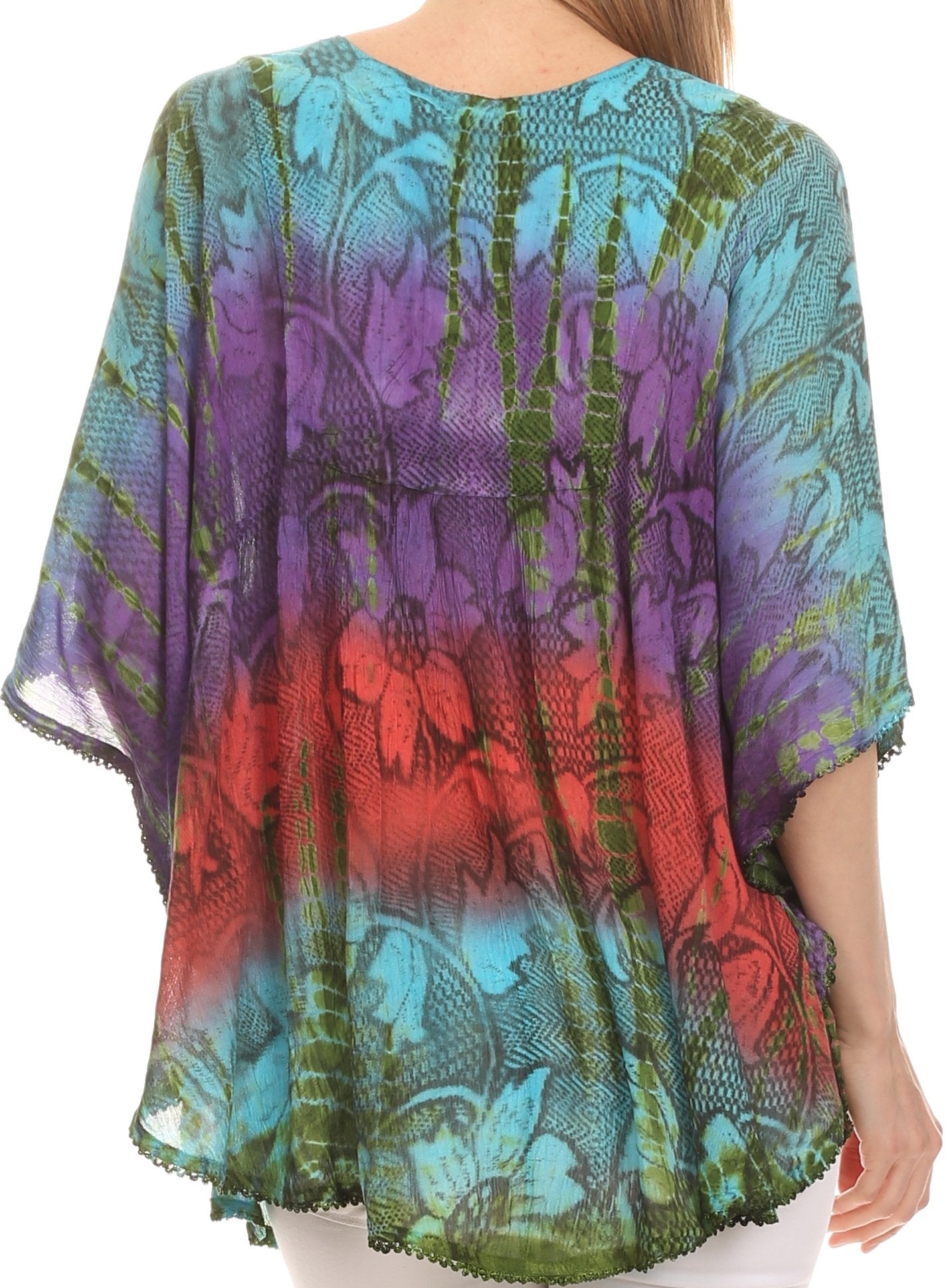 Colorful floral patterned top worn by a person on a white background