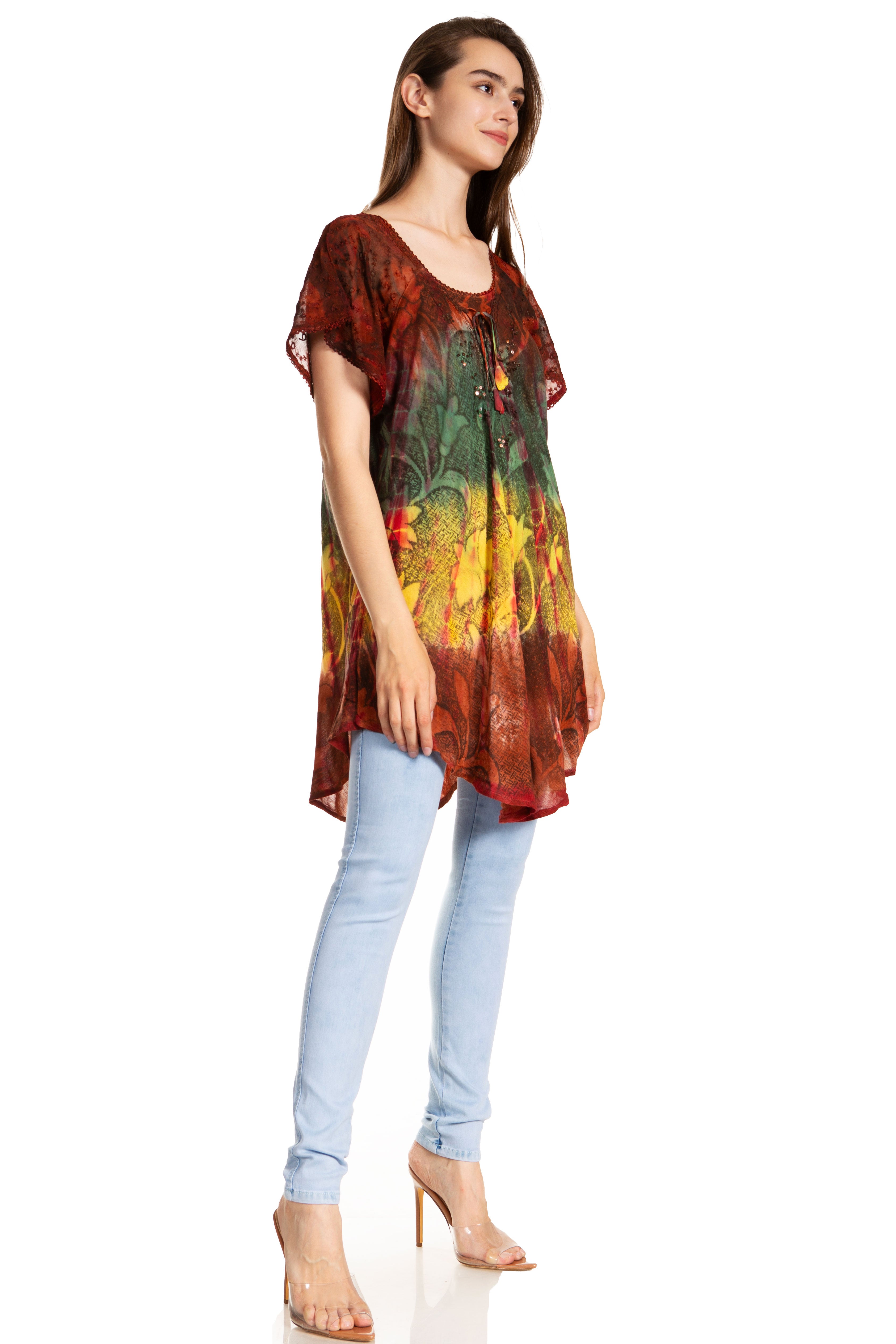 Woman wearing a colorful tie-dye shirt and light blue jeans on a white background