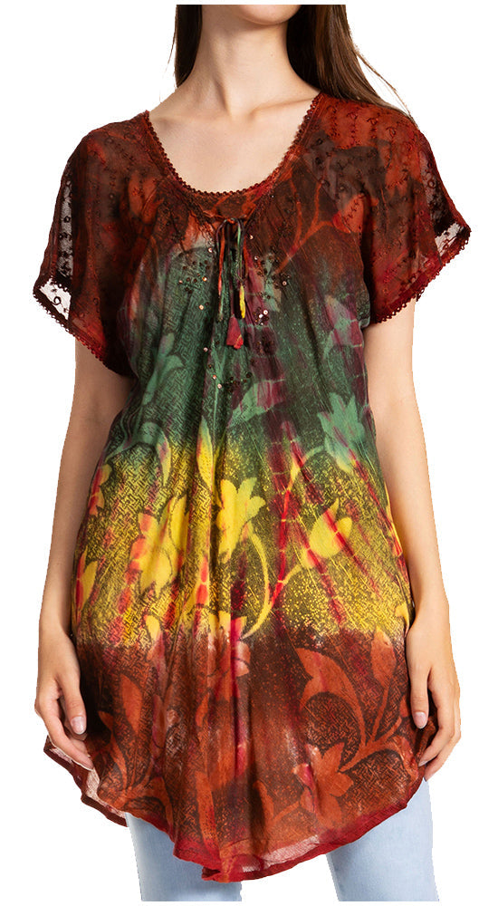 Woman wearing a colorful floral blouse with a red and green pattern.