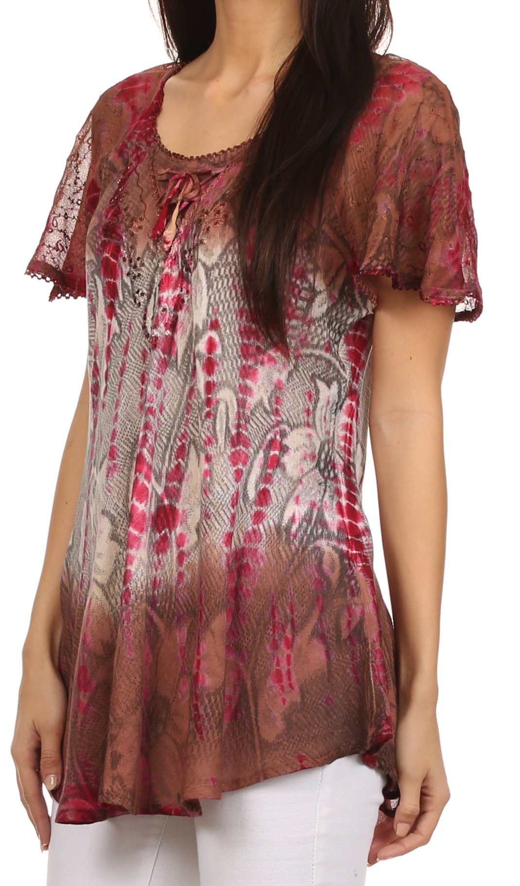 Woman wearing a patterned sheer top with lace sleeves on a white background