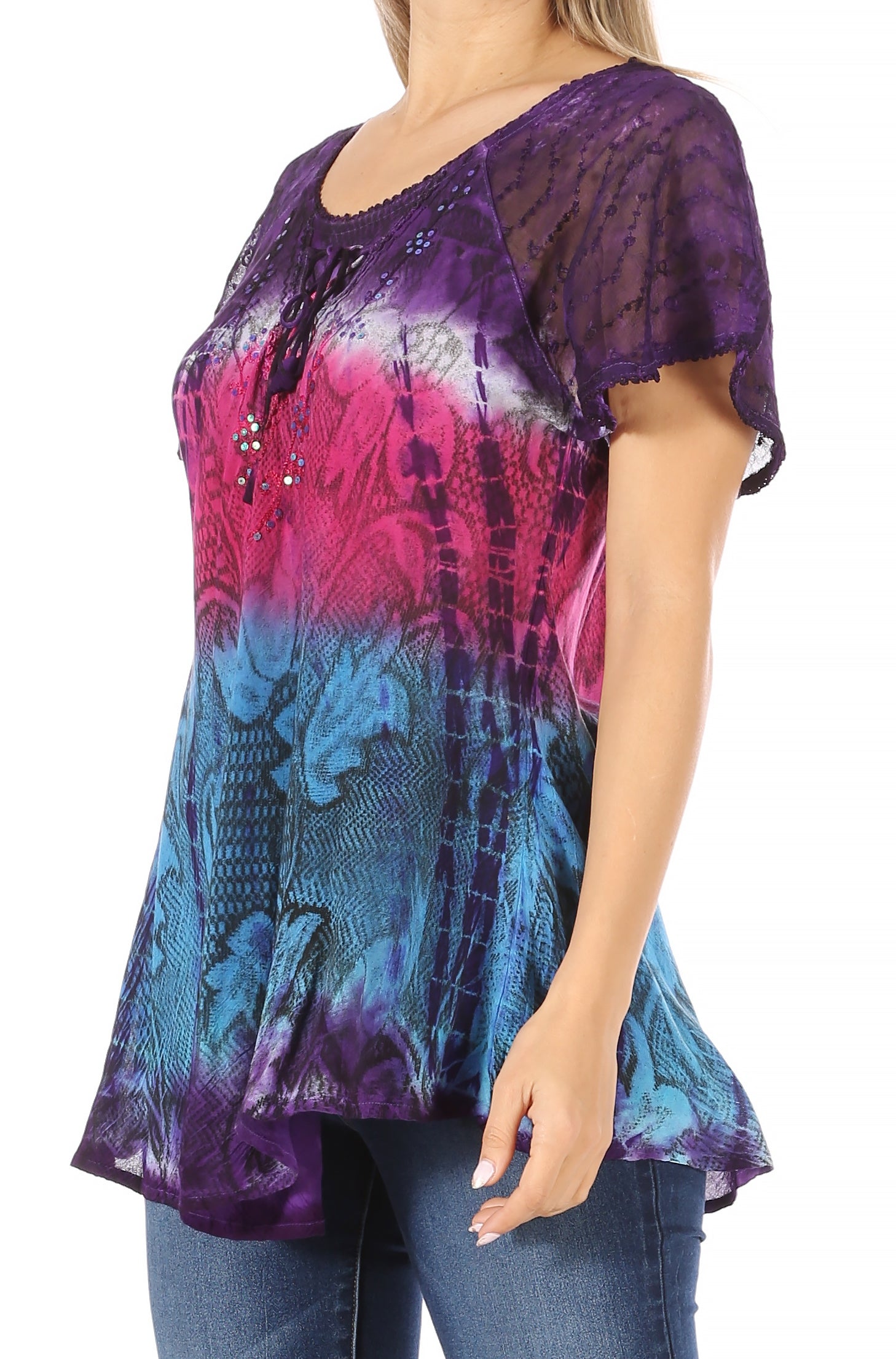 Woman wearing a colorful patterned top with a white background