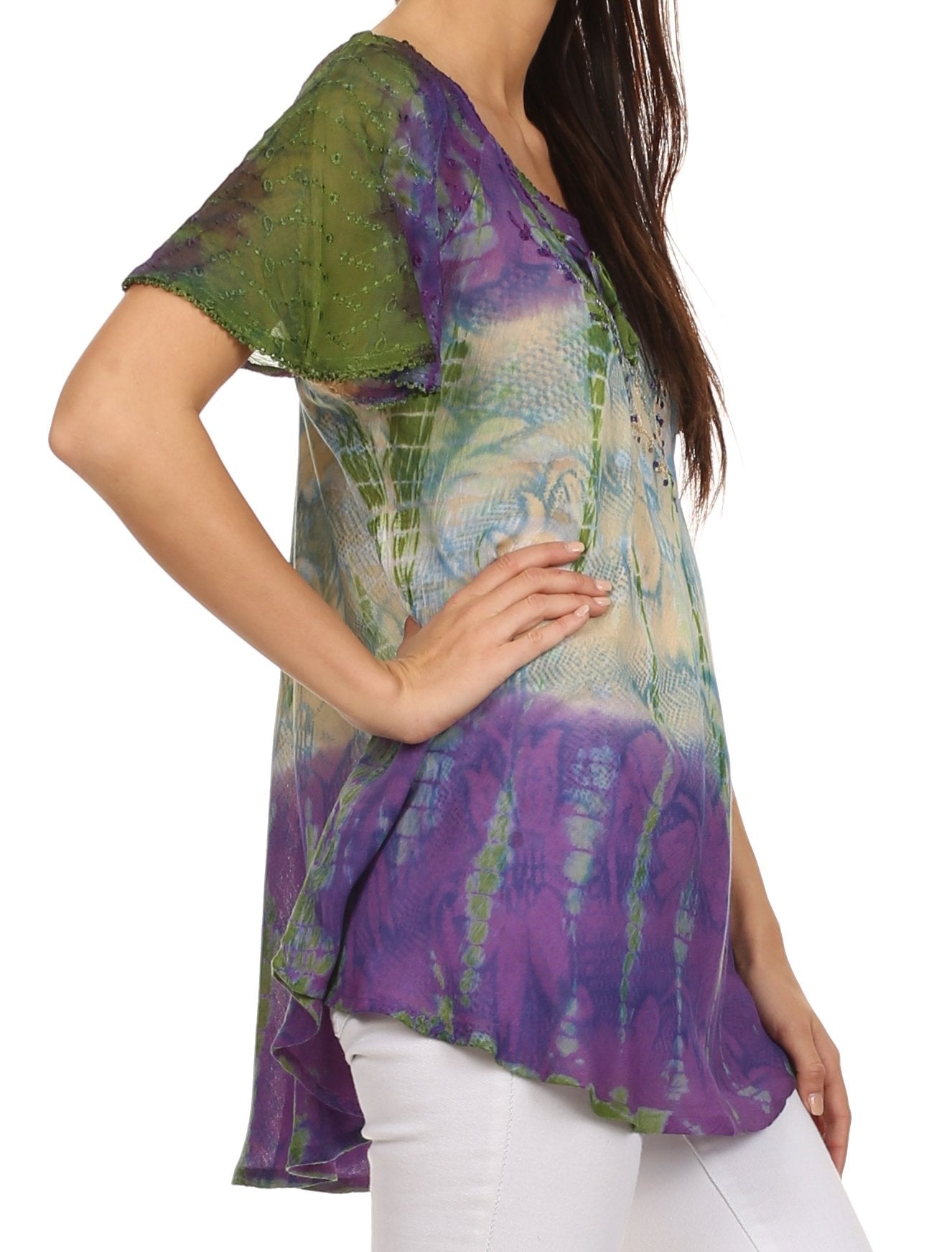 Woman wearing a colorful, patterned top with a white background