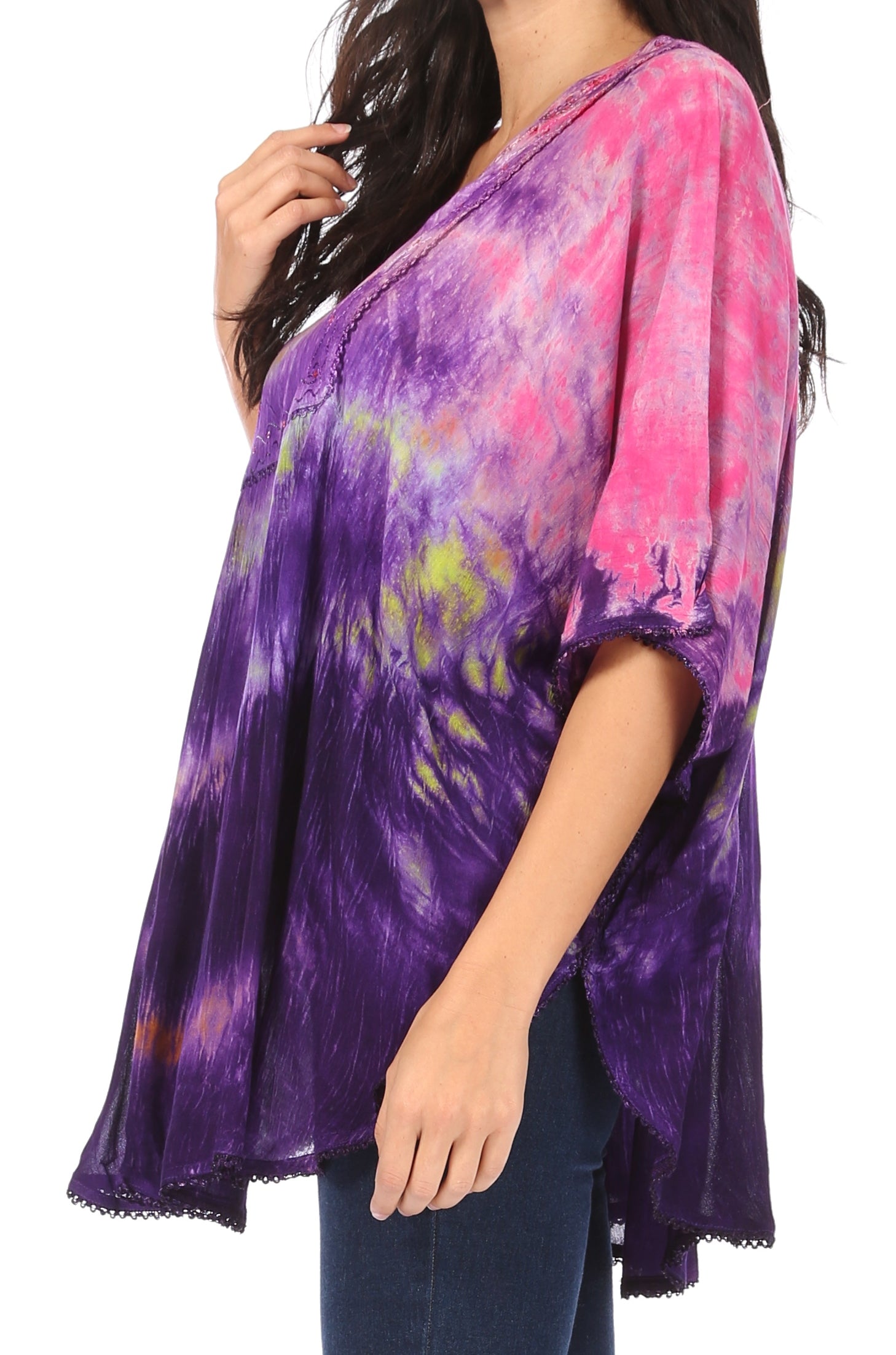 Woman wearing a tie-dye shirt with purple, pink, and green colors on a white background