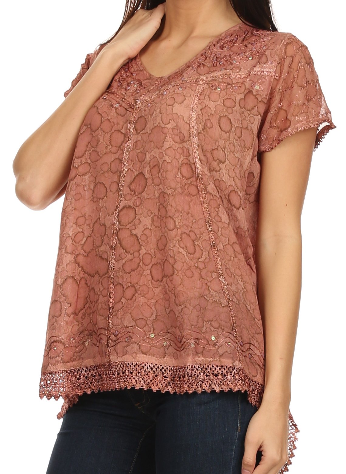 Pink lace top worn by a person on a white background
