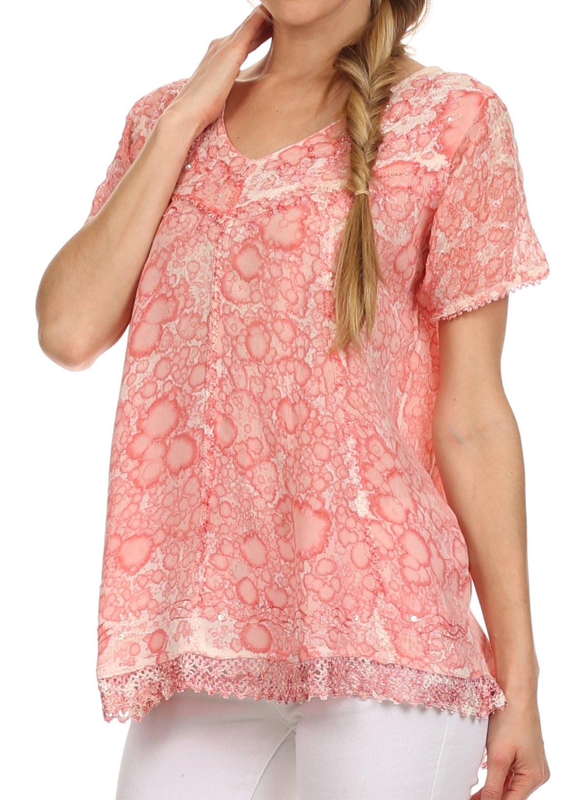 Woman wearing a pink lace top with a white background