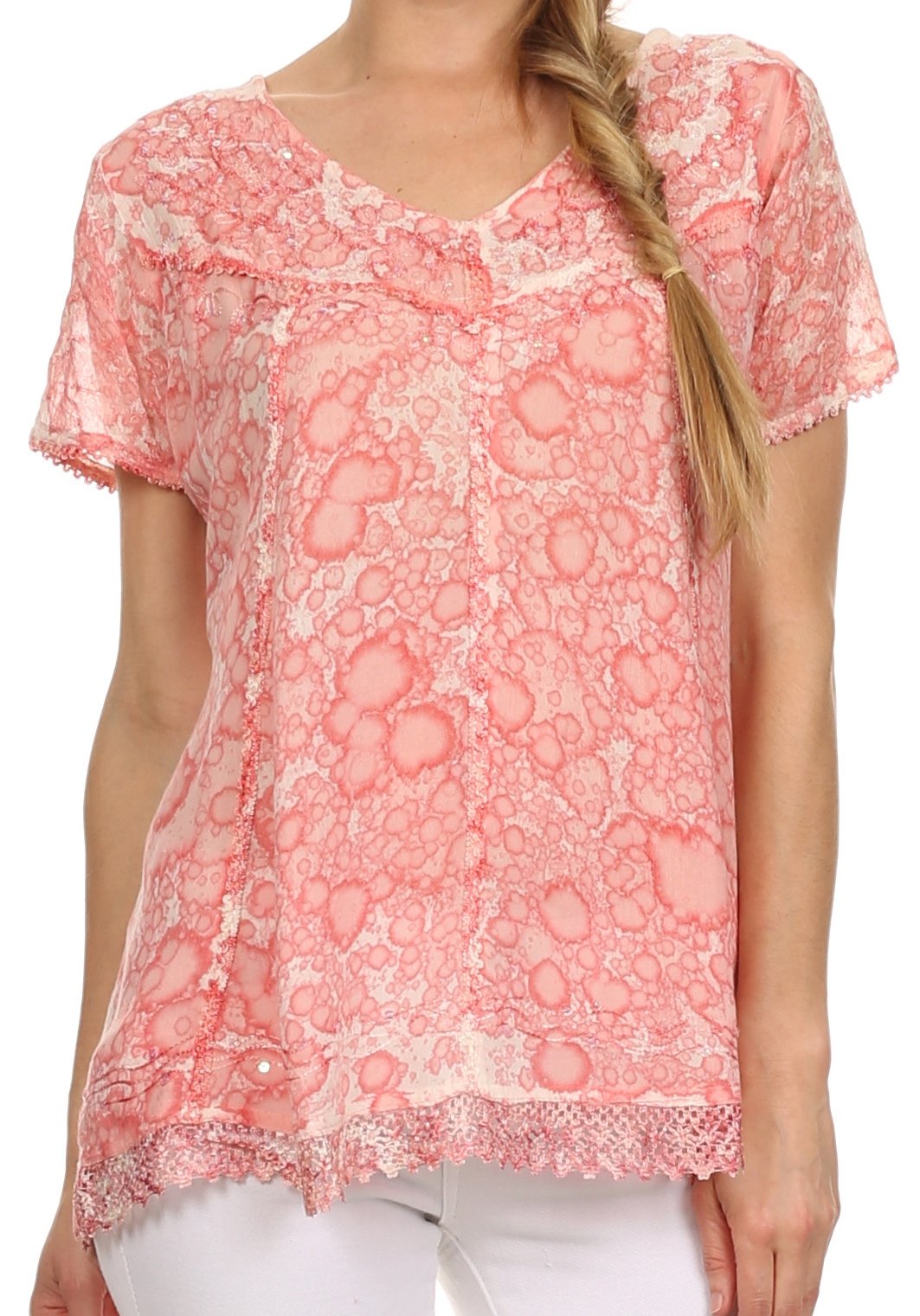Woman wearing a pink lace top on a white background