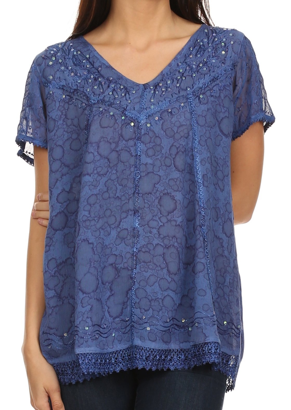 Blue lace top worn by a person on a white background