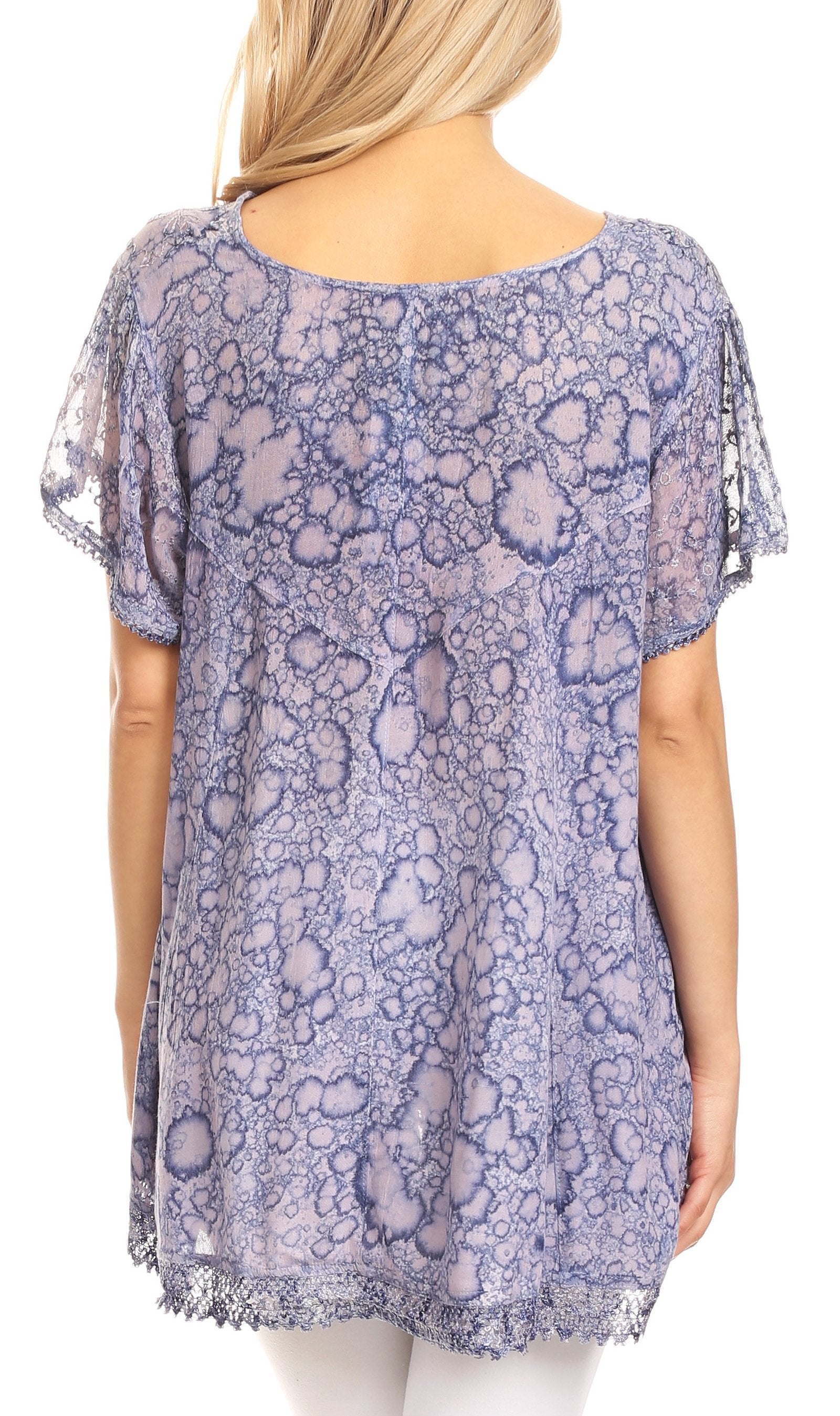 Purple floral patterned blouse worn by a person on a white background