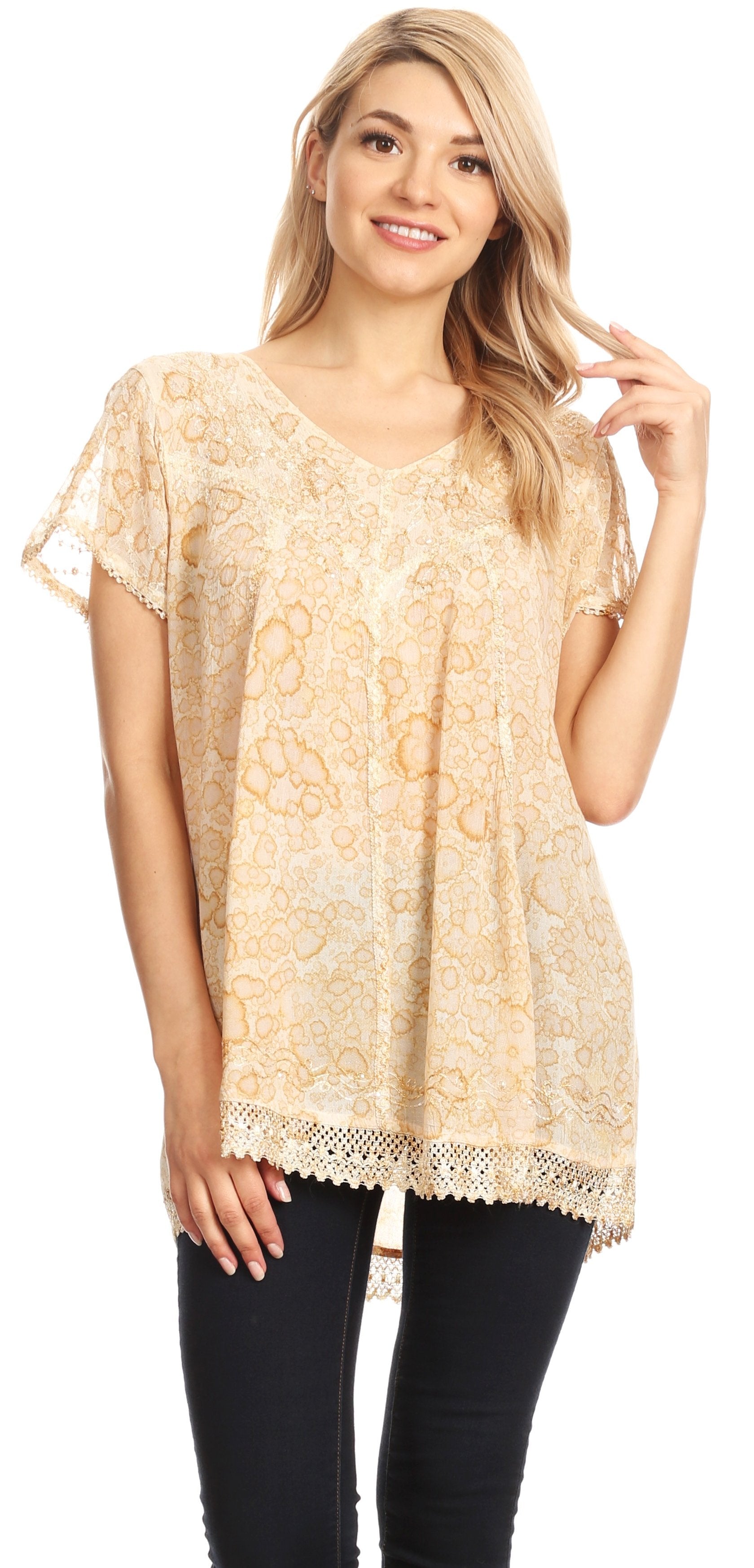 Woman wearing a beige lace top and black pants on a white background