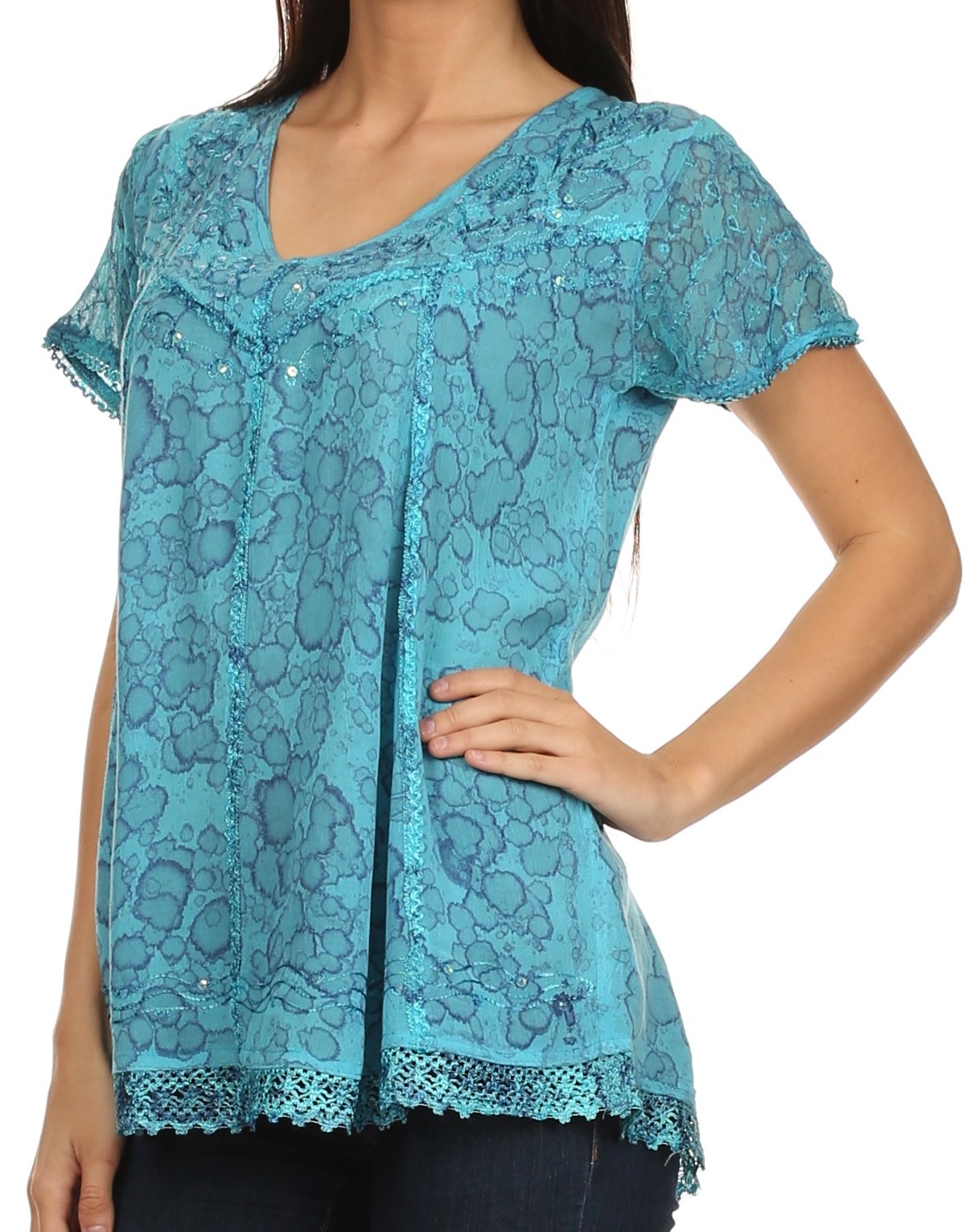 Teal lace top worn by a person on a white background