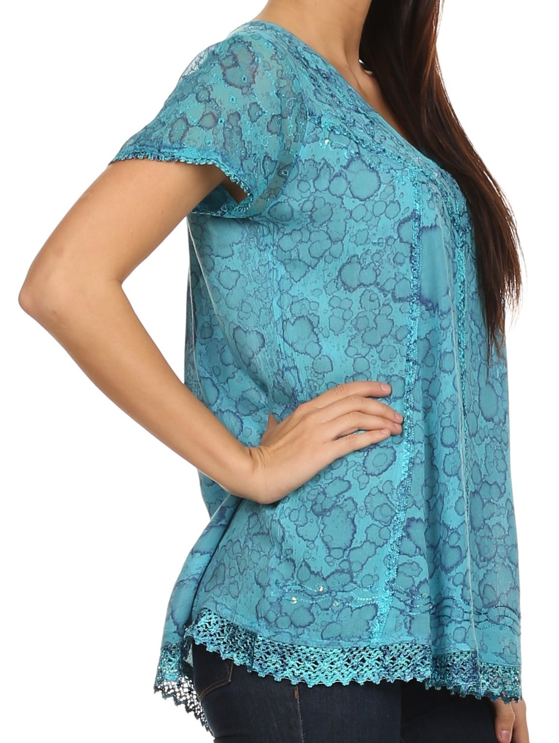 Teal lace top worn by a person on a white background