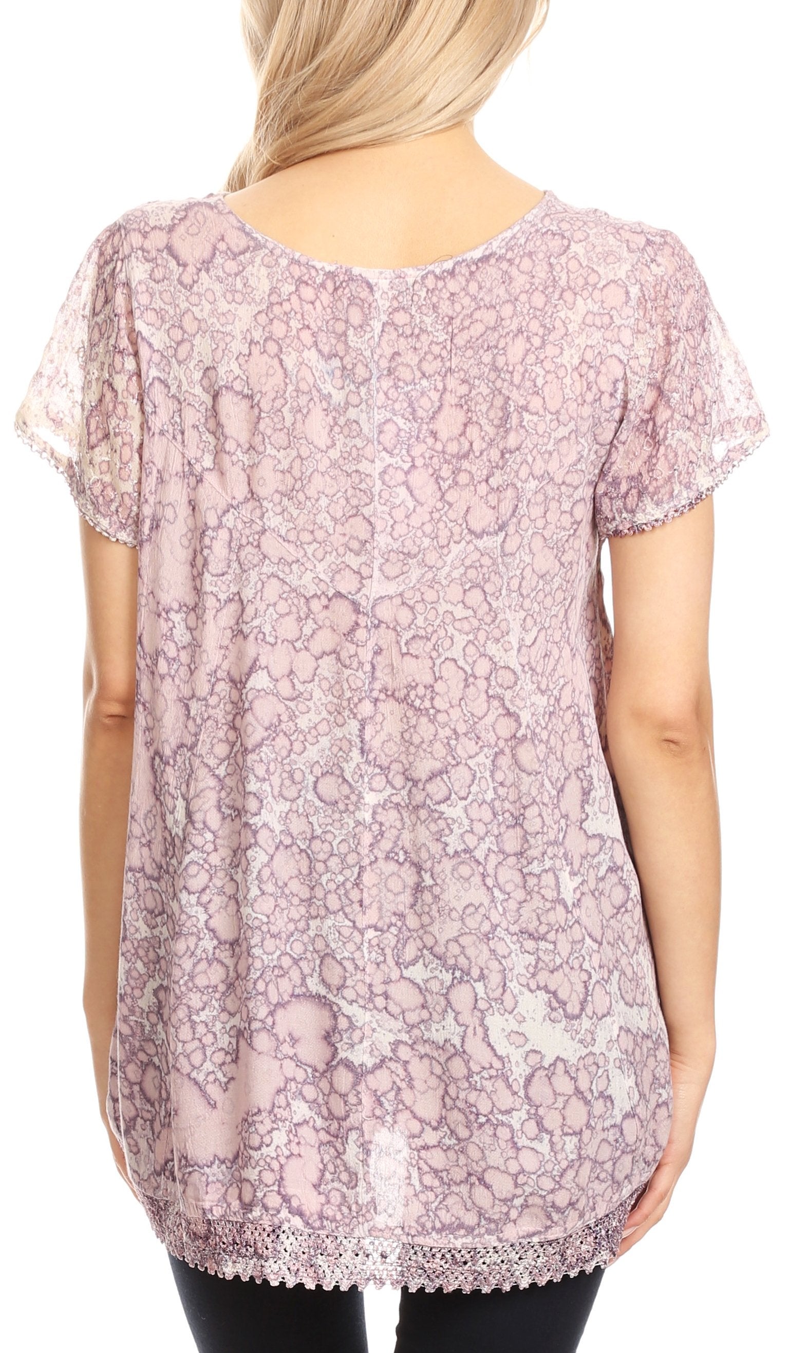 Woman wearing a pink floral lace top on a white background