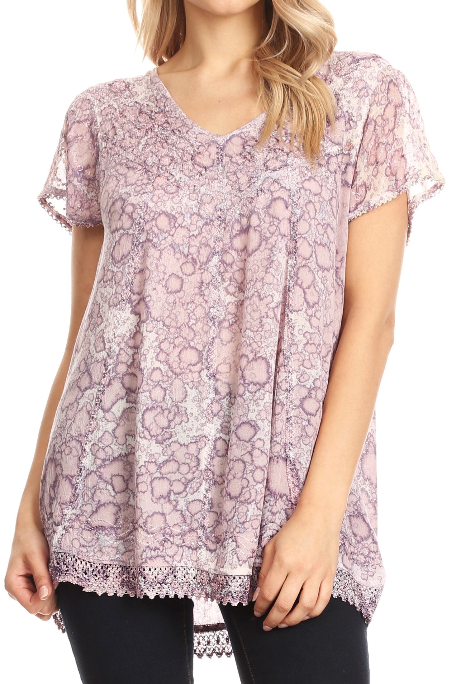 Woman wearing a floral lace top with a white background