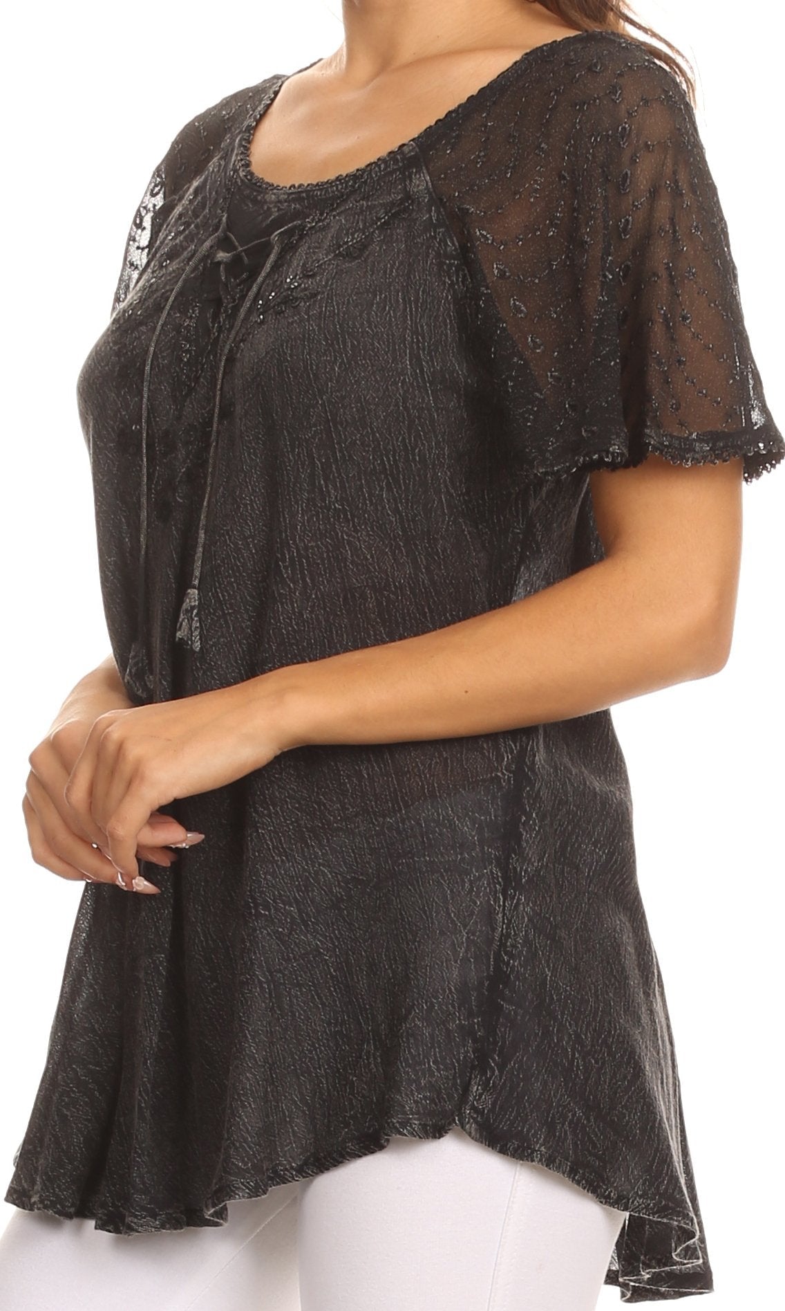 Black lace top worn by a person on a white background