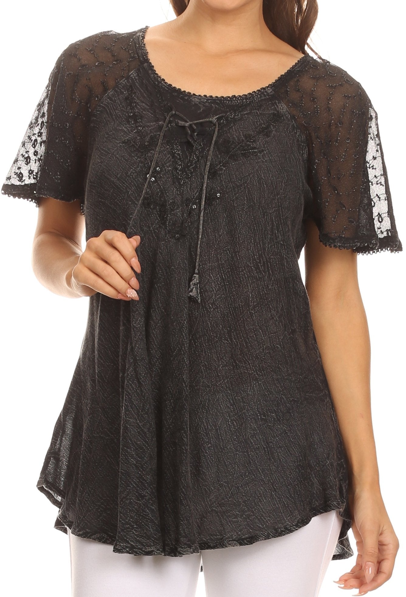 Black lace top worn by a person on a white background