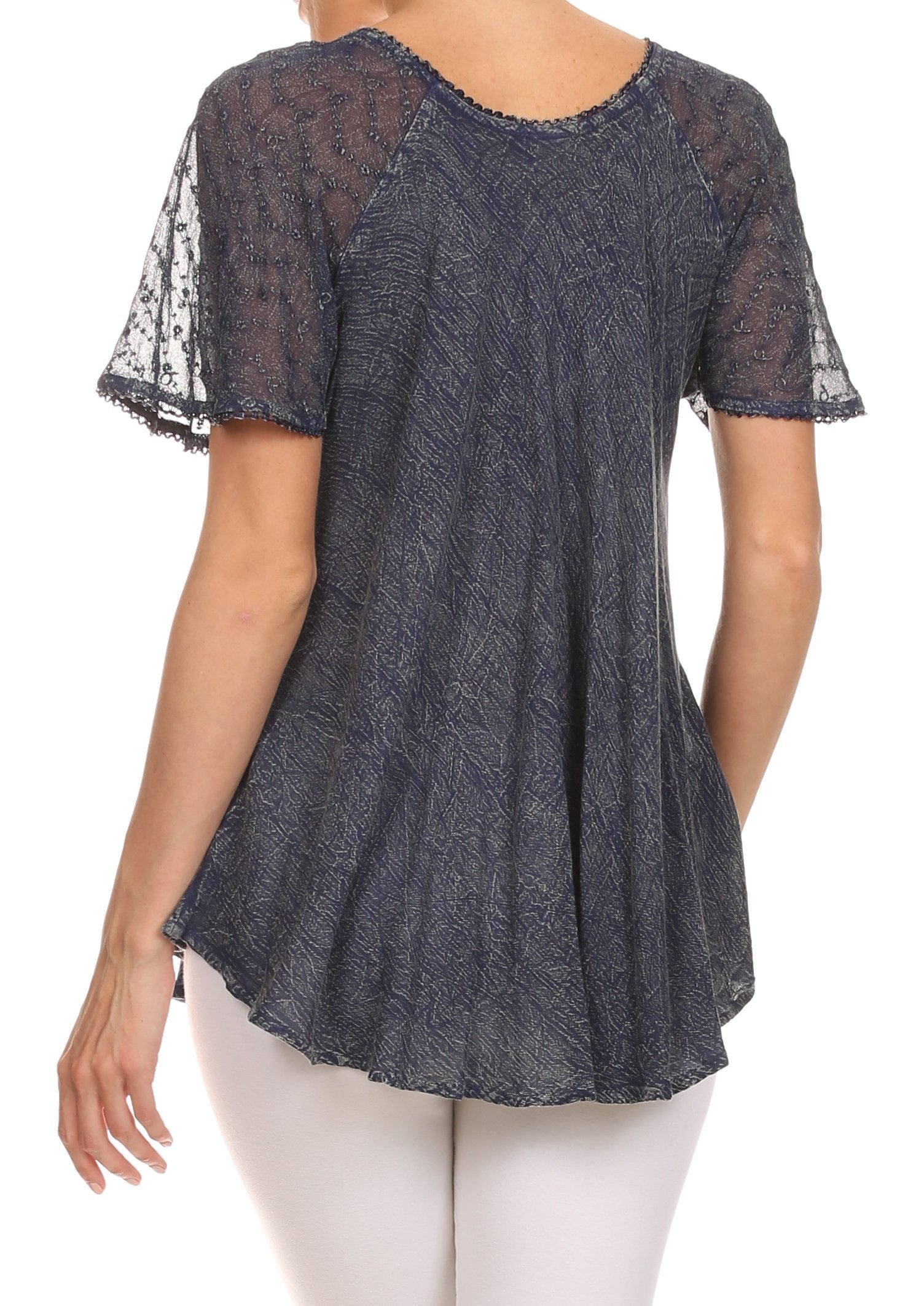 Dark blue lace top with sheer sleeves worn by a person on a white background