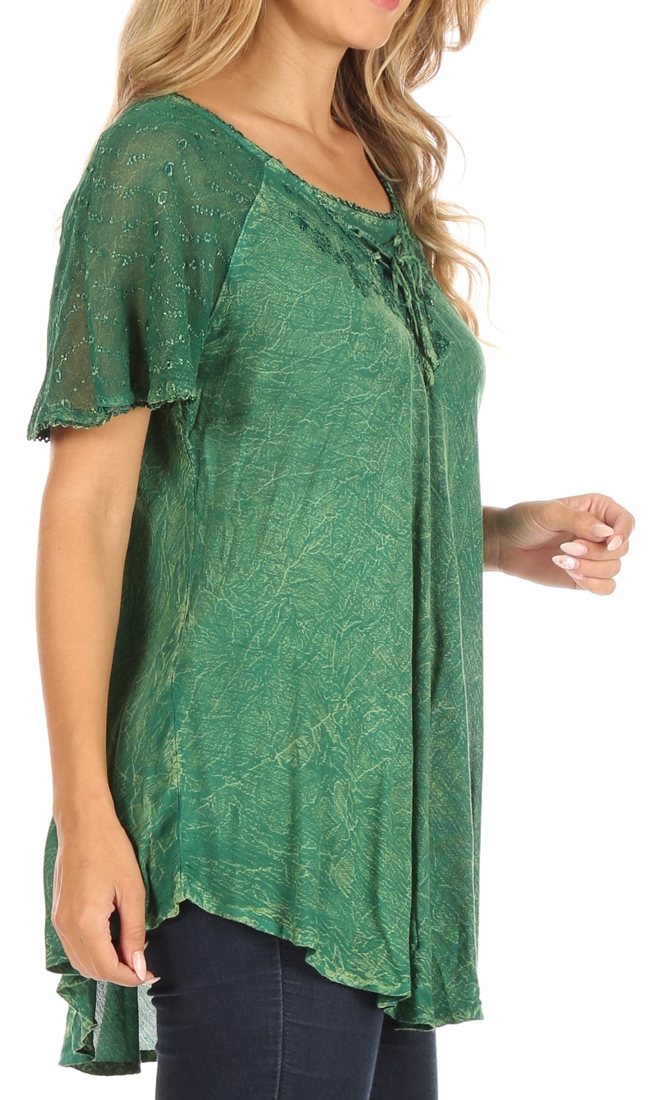 Green patterned top worn by a person on a white background