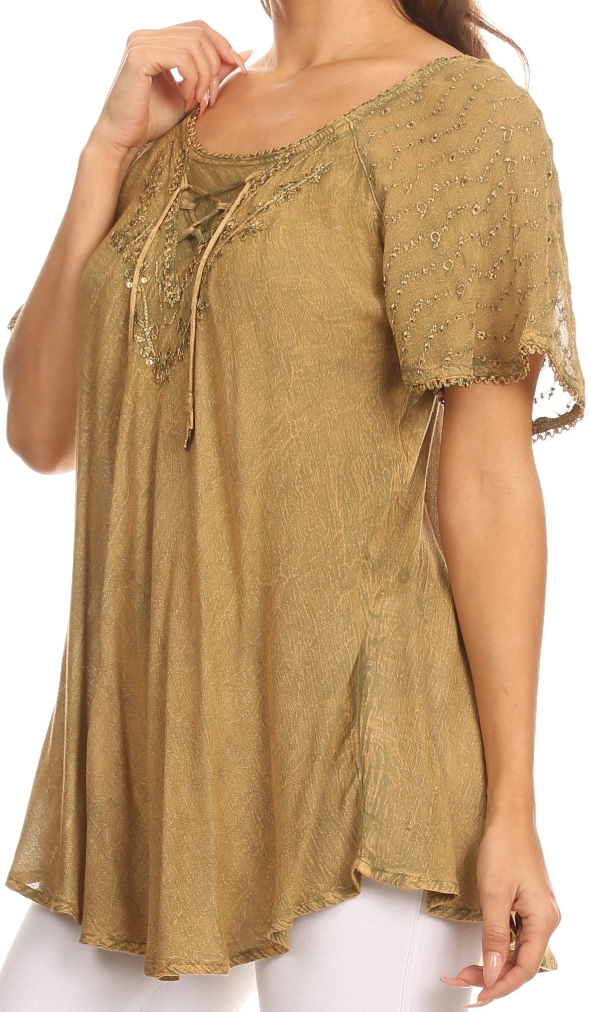 Woman wearing a gold embroidered blouse on a white background