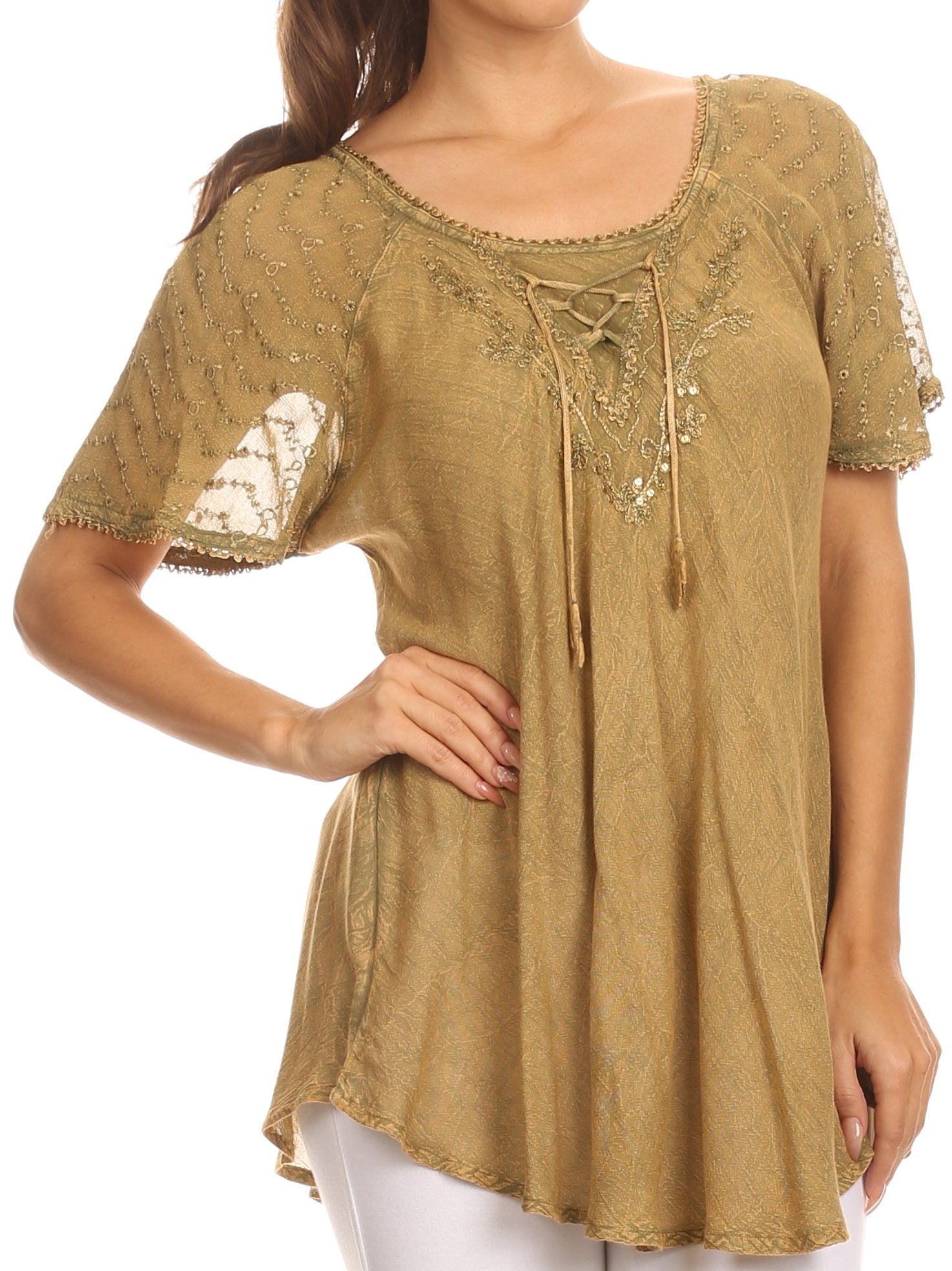 Woman wearing a gold embroidered top on a white background