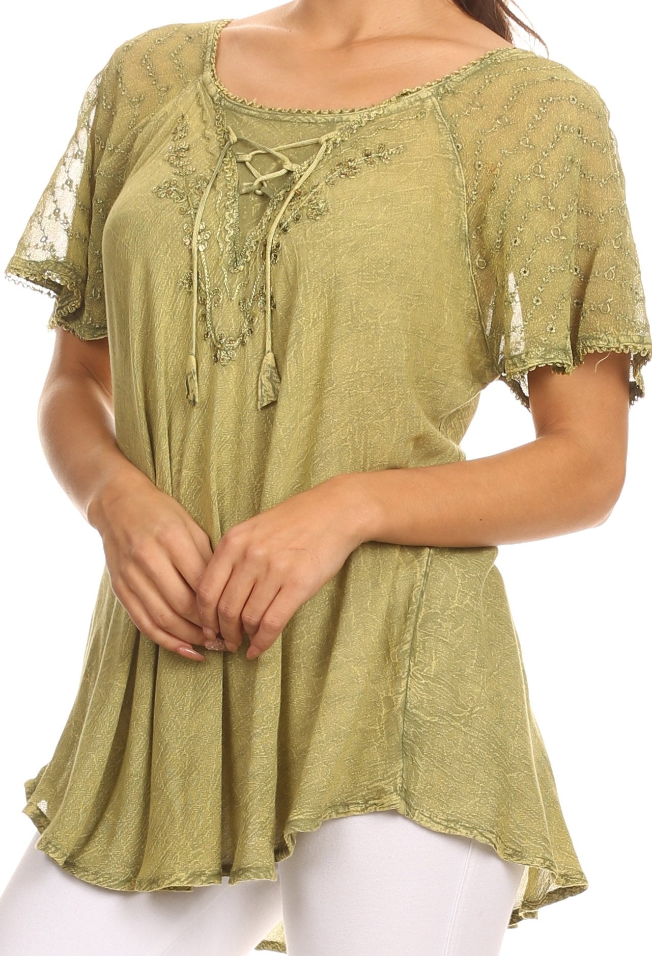 Green embroidered top worn by a person on a white background