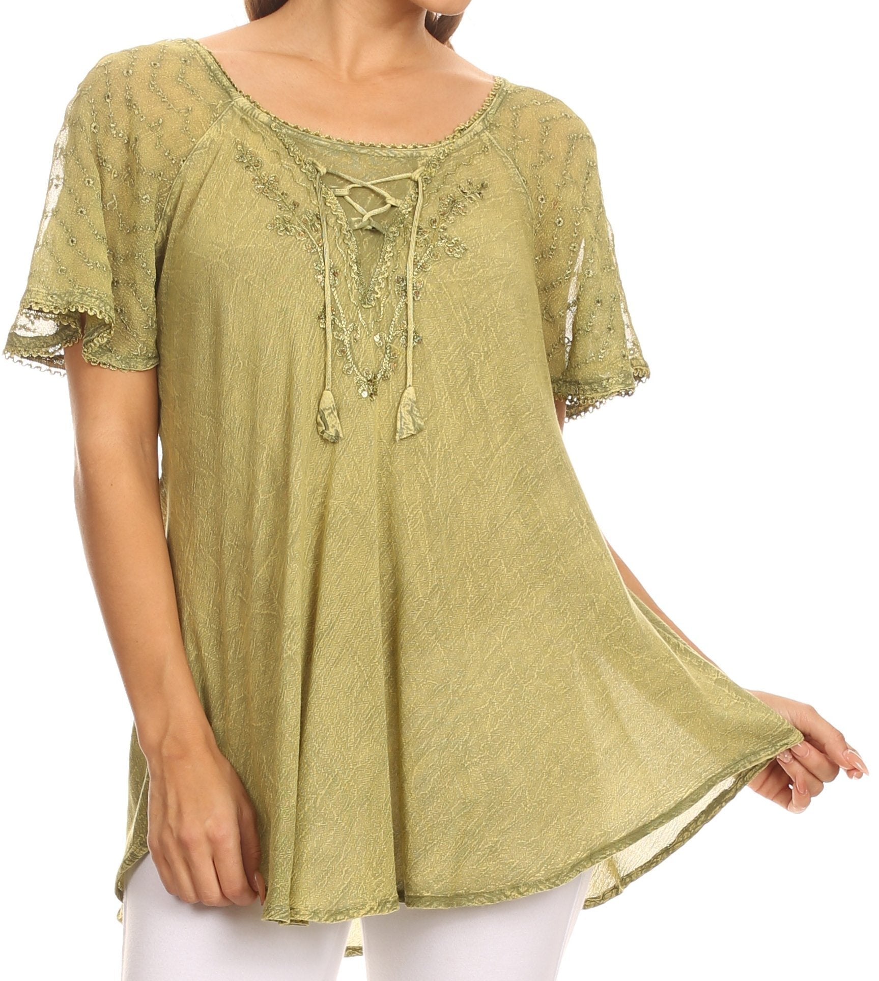 Green embroidered blouse worn by a person on a white background