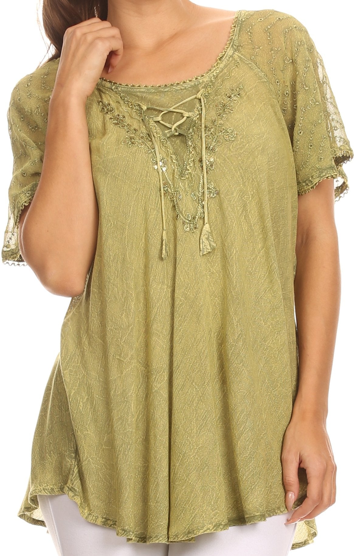Green embroidered blouse worn by a person on a white background